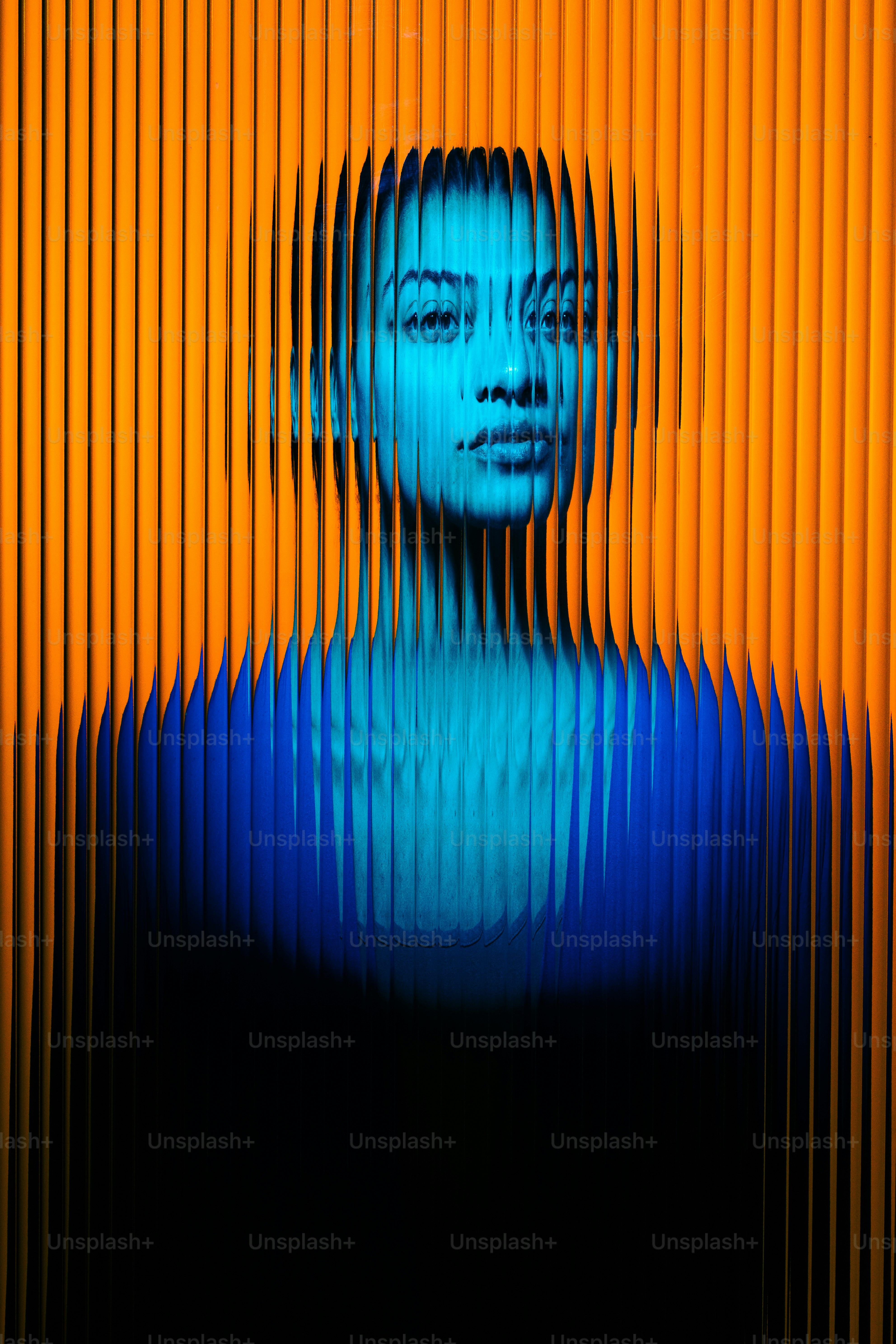Blue lit woman's image through orange lines.