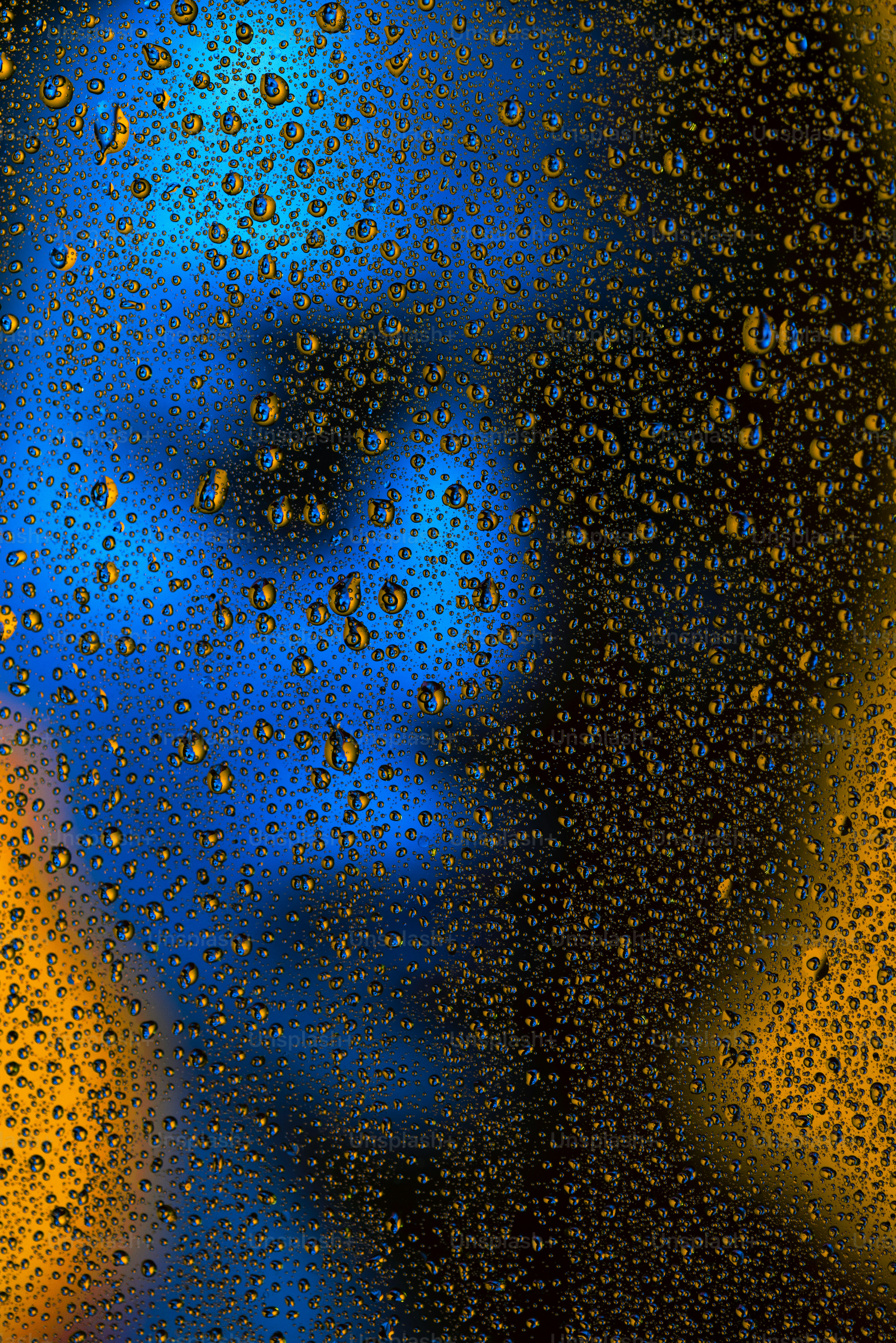 Water droplets overlay a blurred, colorful abstract background.
