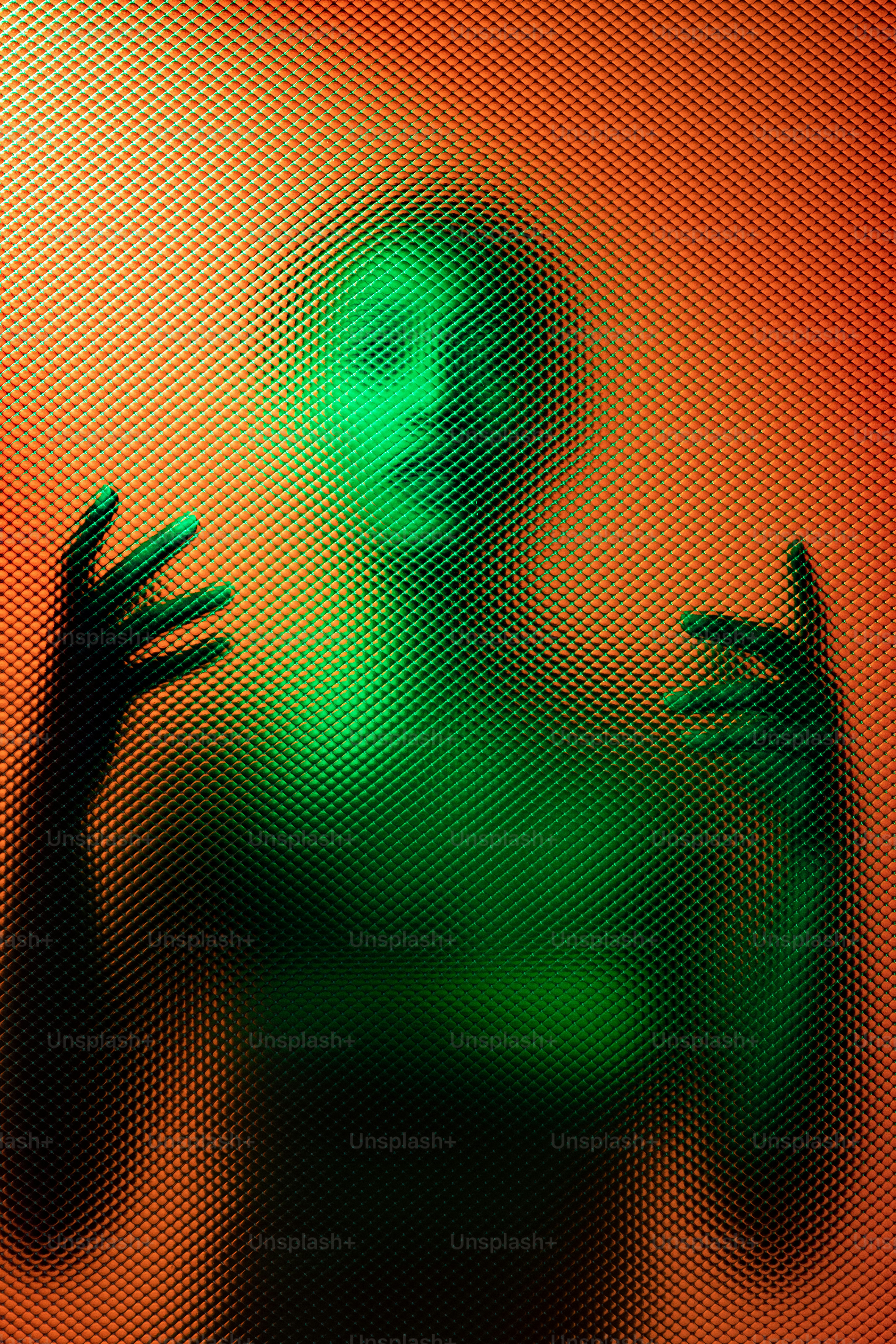 Green figure behind a textured glass pane.