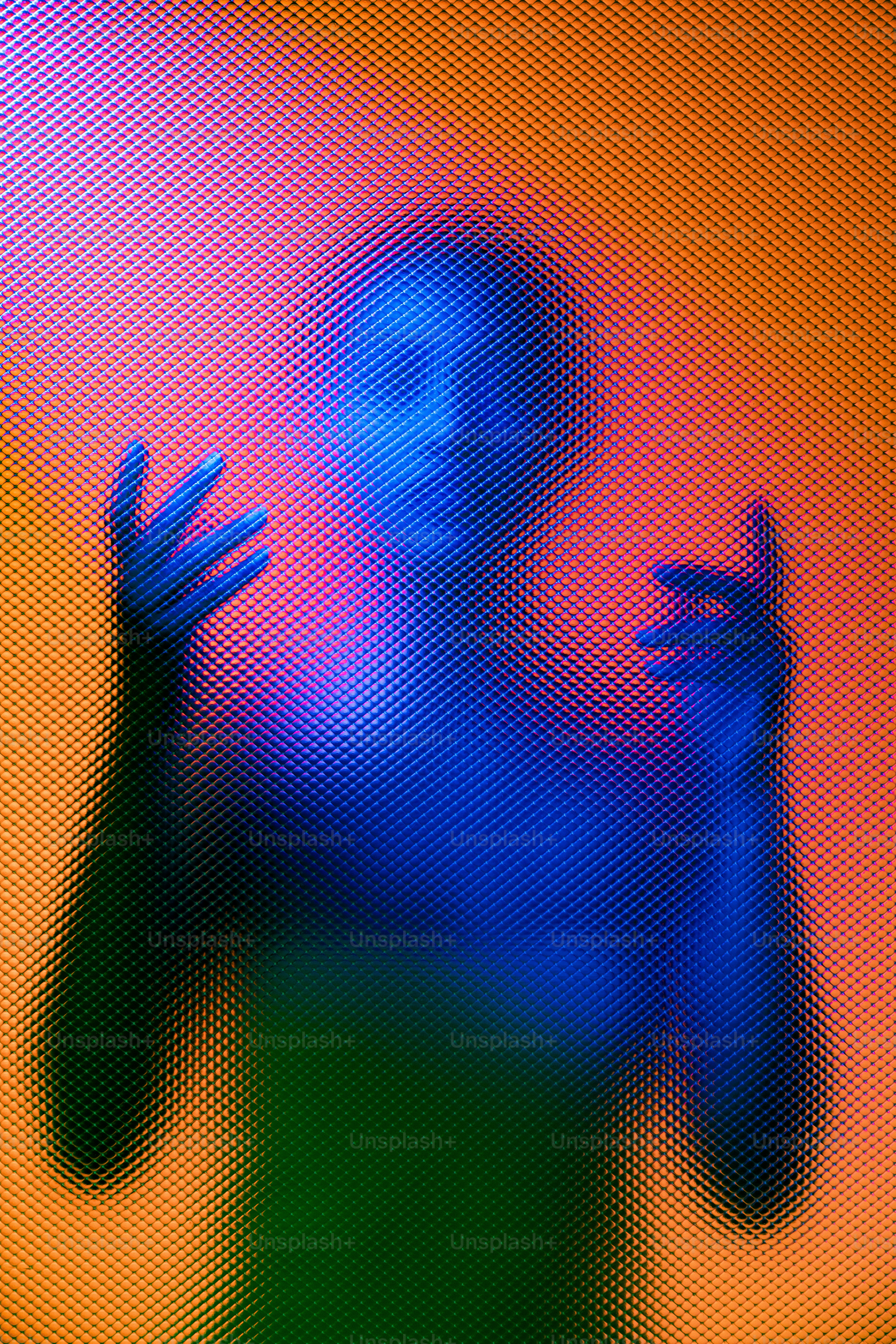 Uma silhueta posa com as mãos levantadas, iluminadas brilhantemente.