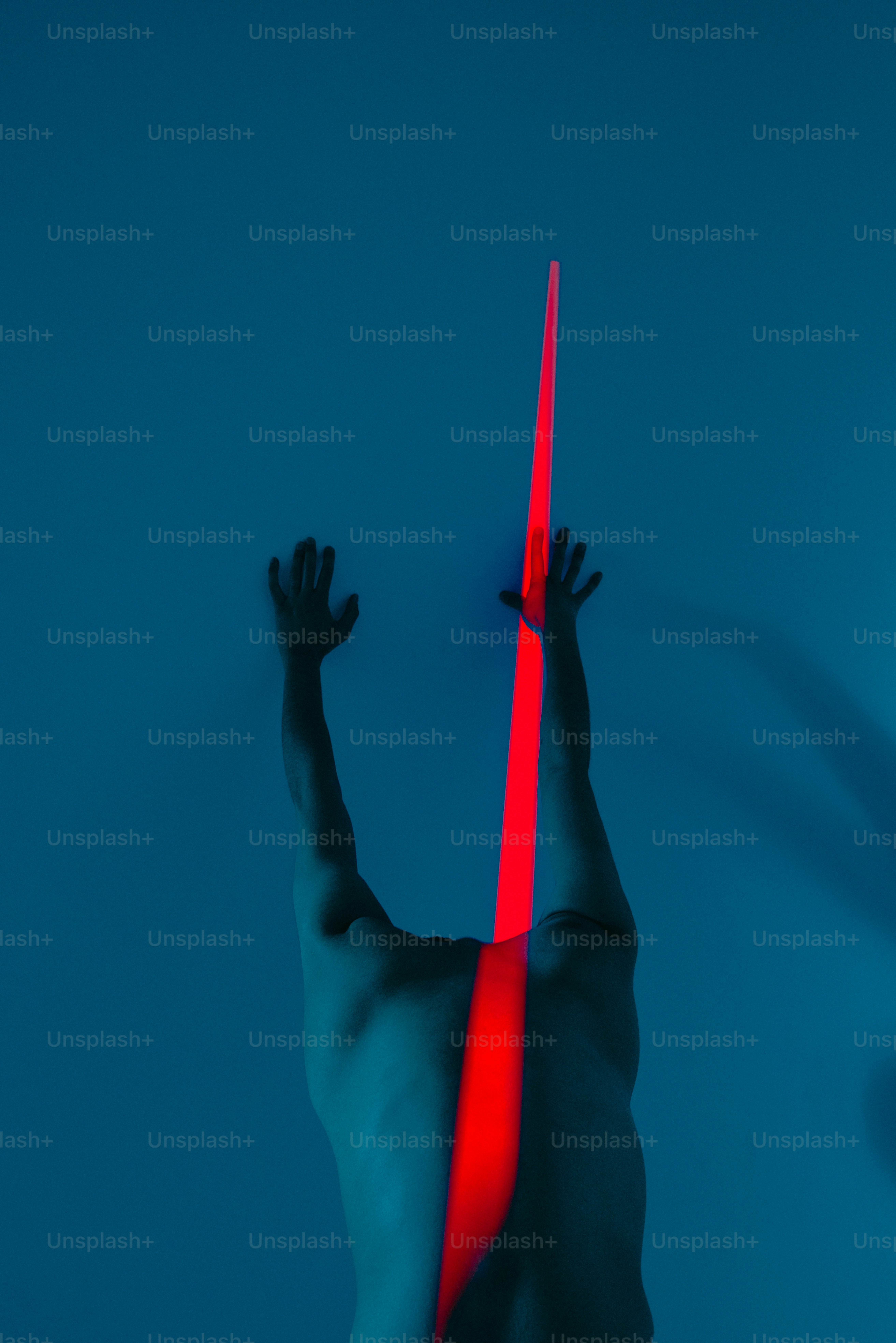 A person is illuminated by red light.