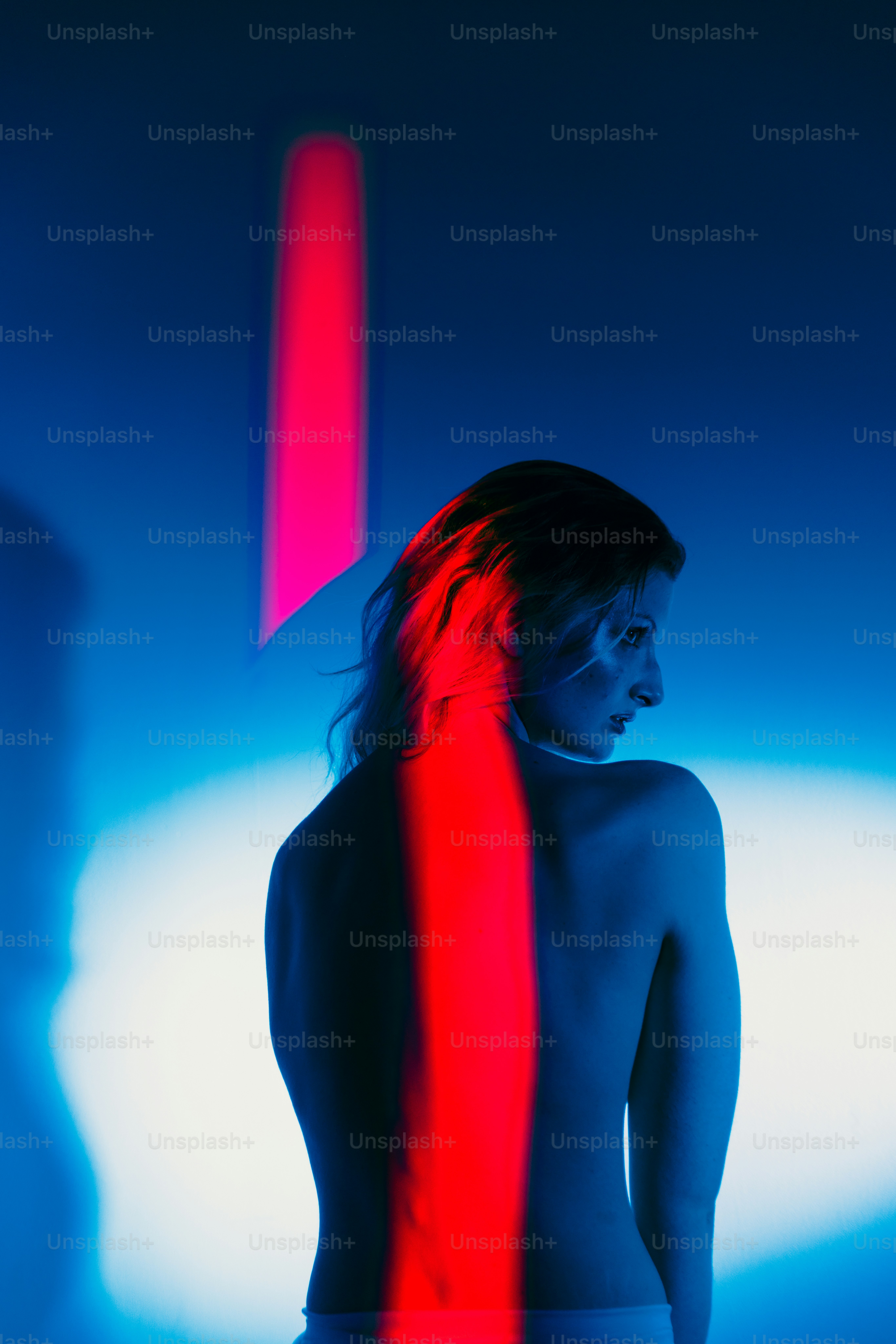 A woman is silhouetted in colorful lights. photo – Portrait Image on ...