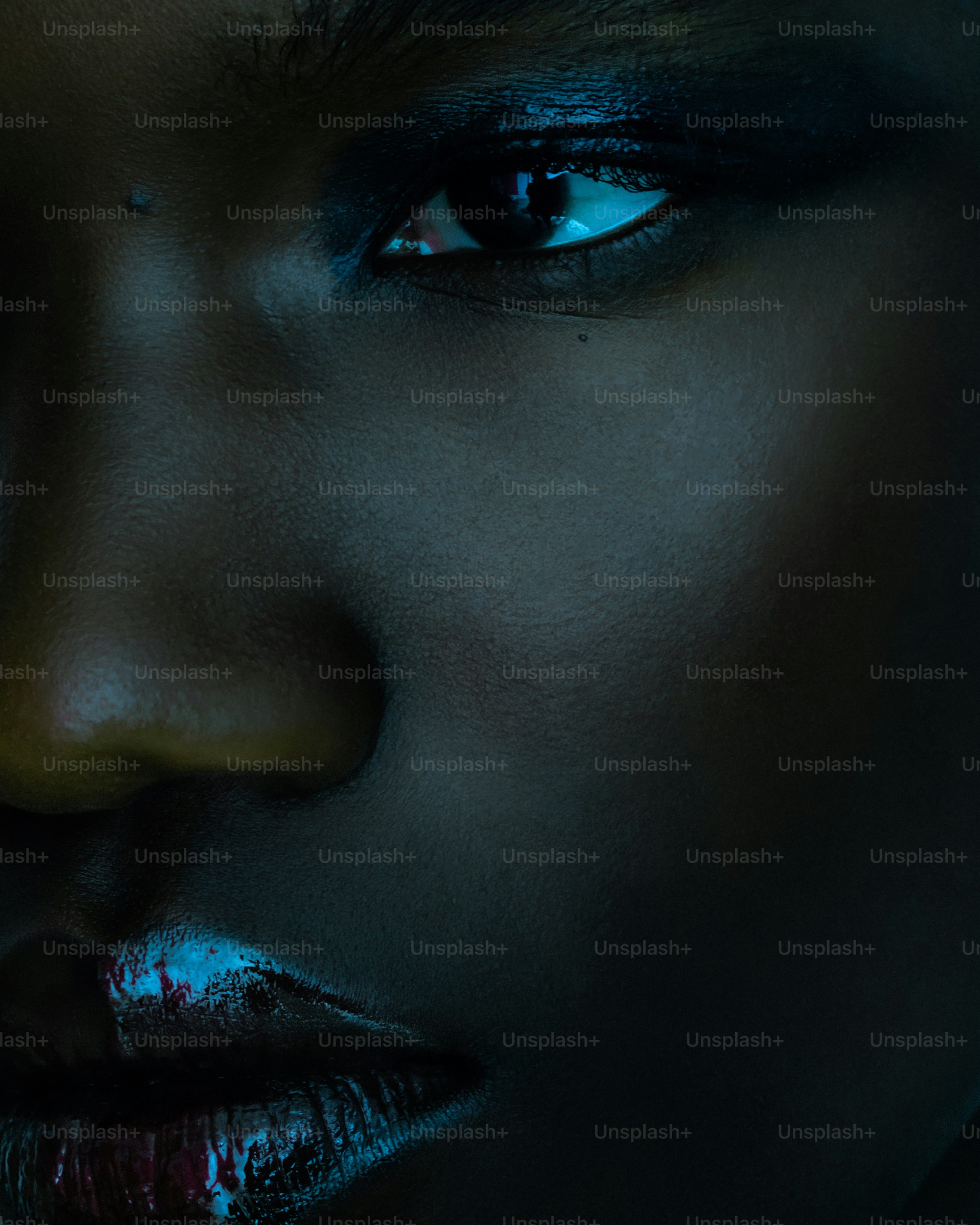 A close-up portrait shows striking eye makeup.