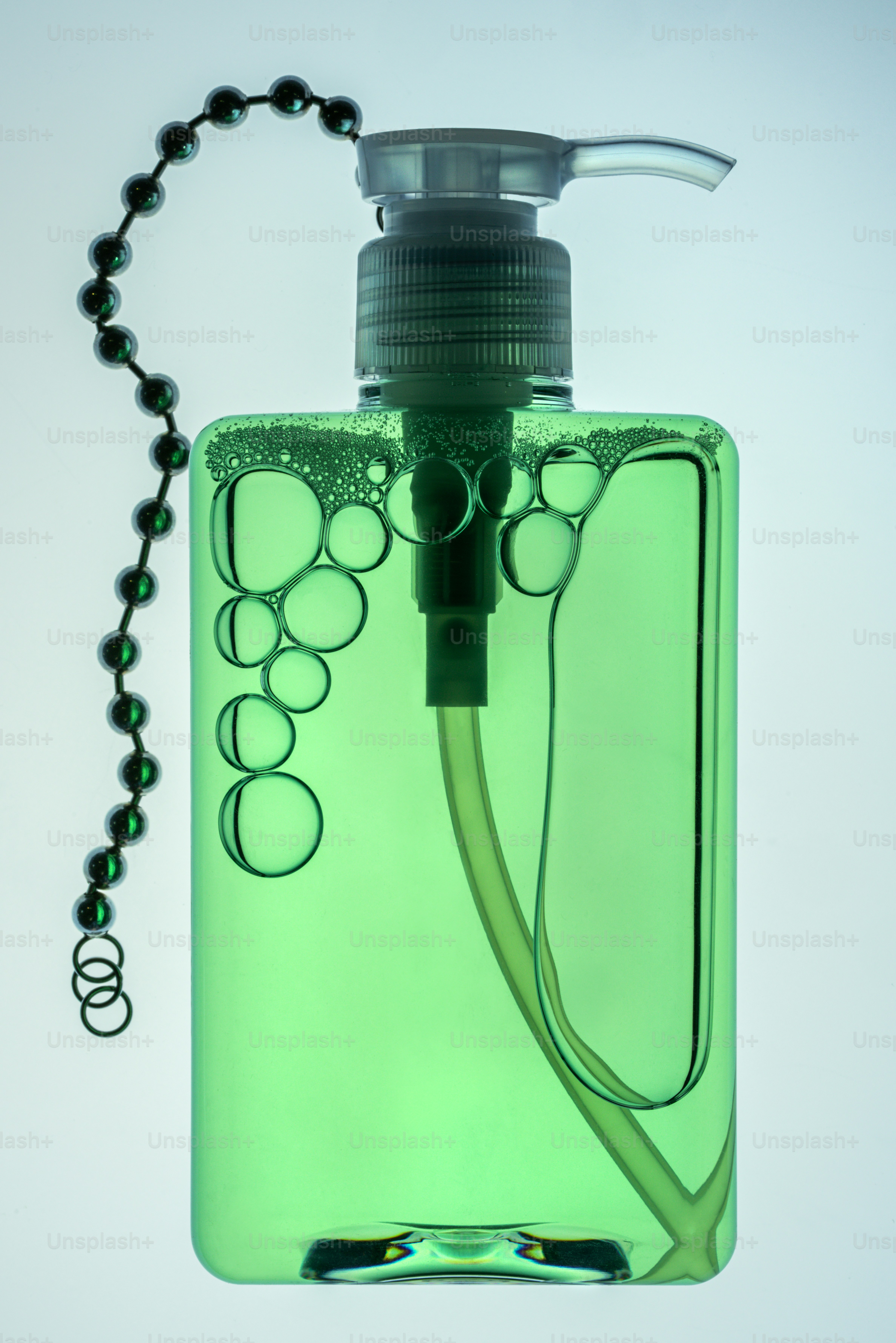 Green soap bottle with bubbles and a pull chain.