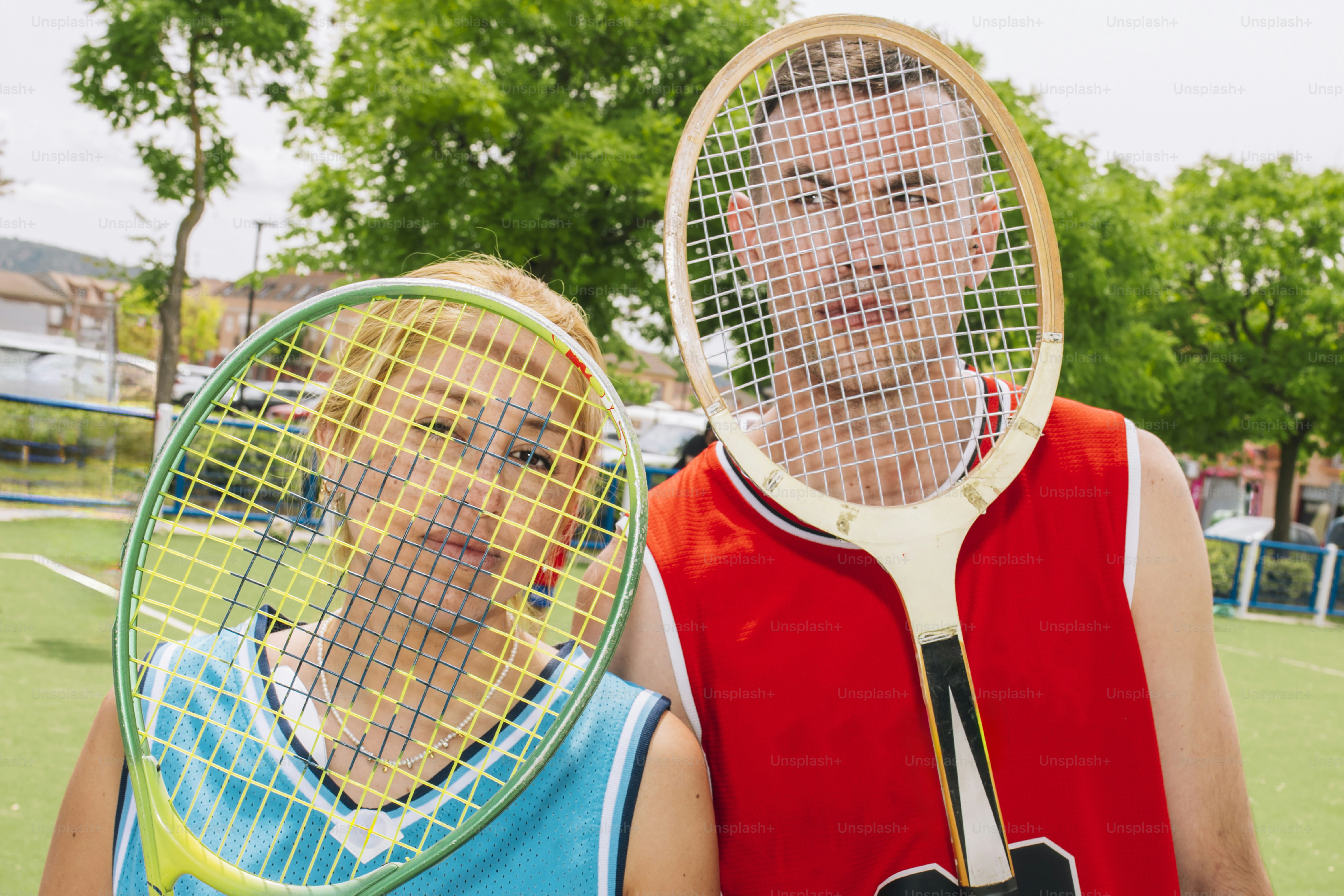 Two people pose on a tennis court with rackets. photo – Sport Image on ...