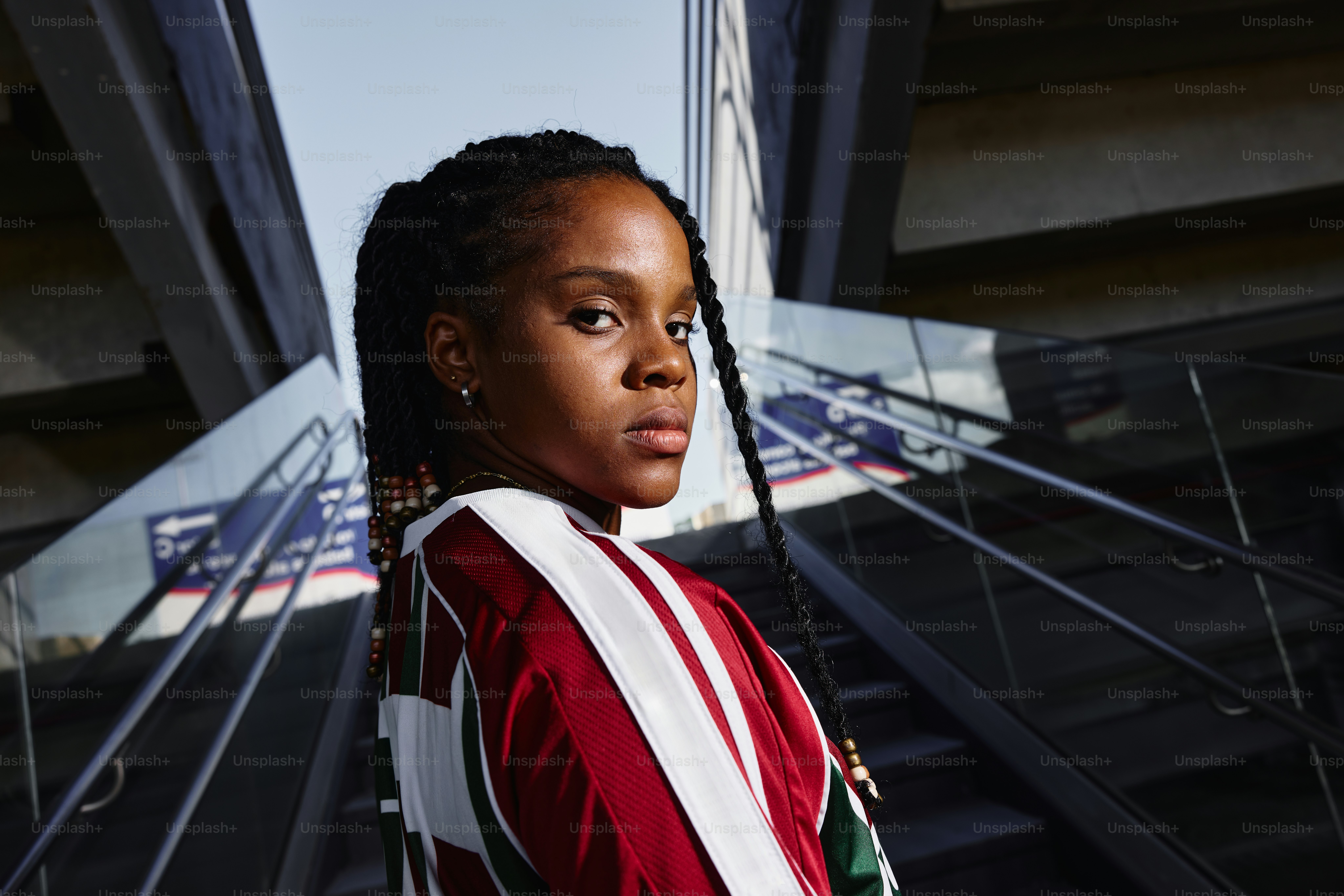A young woman poses with braids.