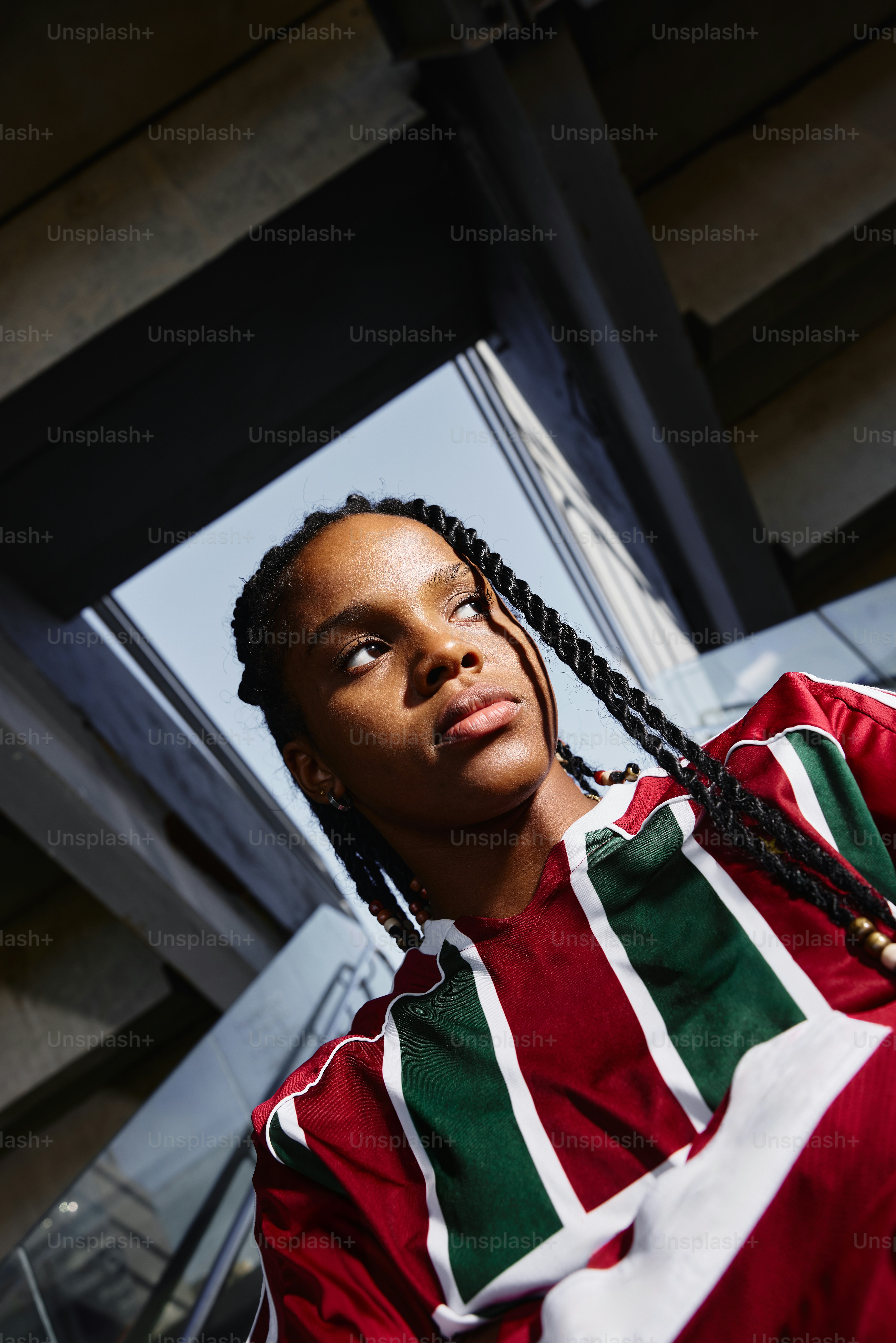 A young person poses in a stylish shirt.
