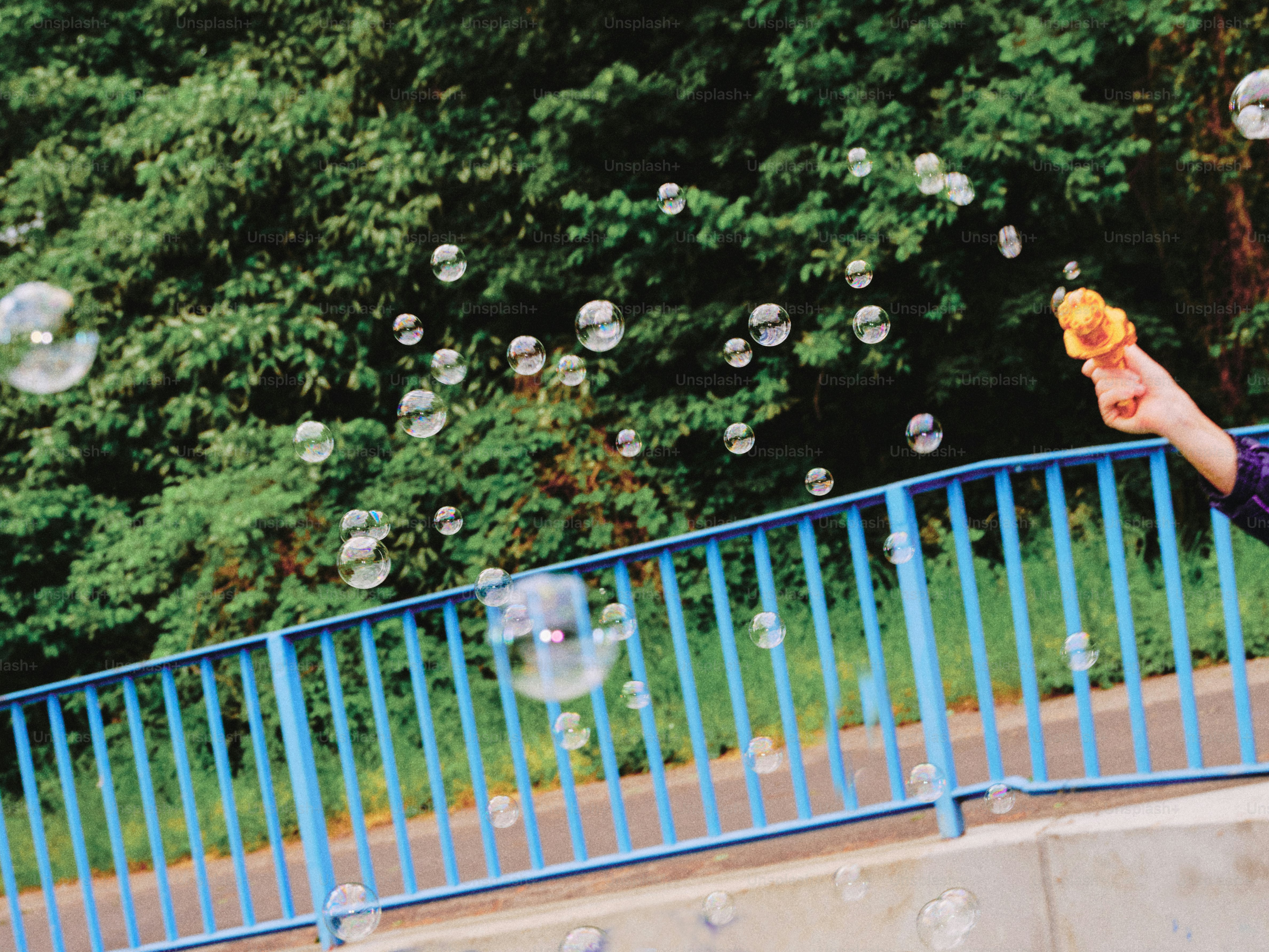 Bubbles floating in the air near a park.