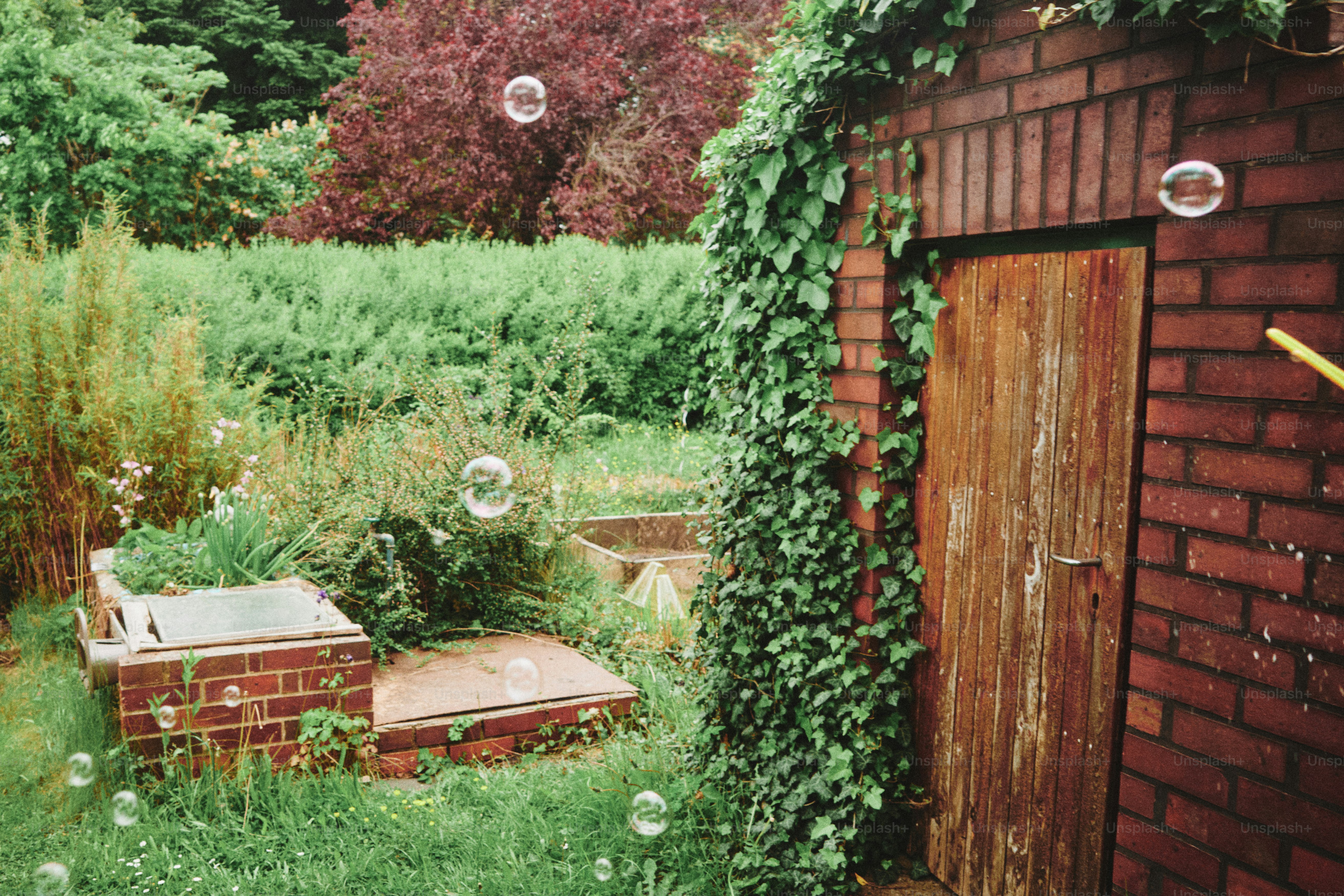 Bubbles float in a backyard with brick details.