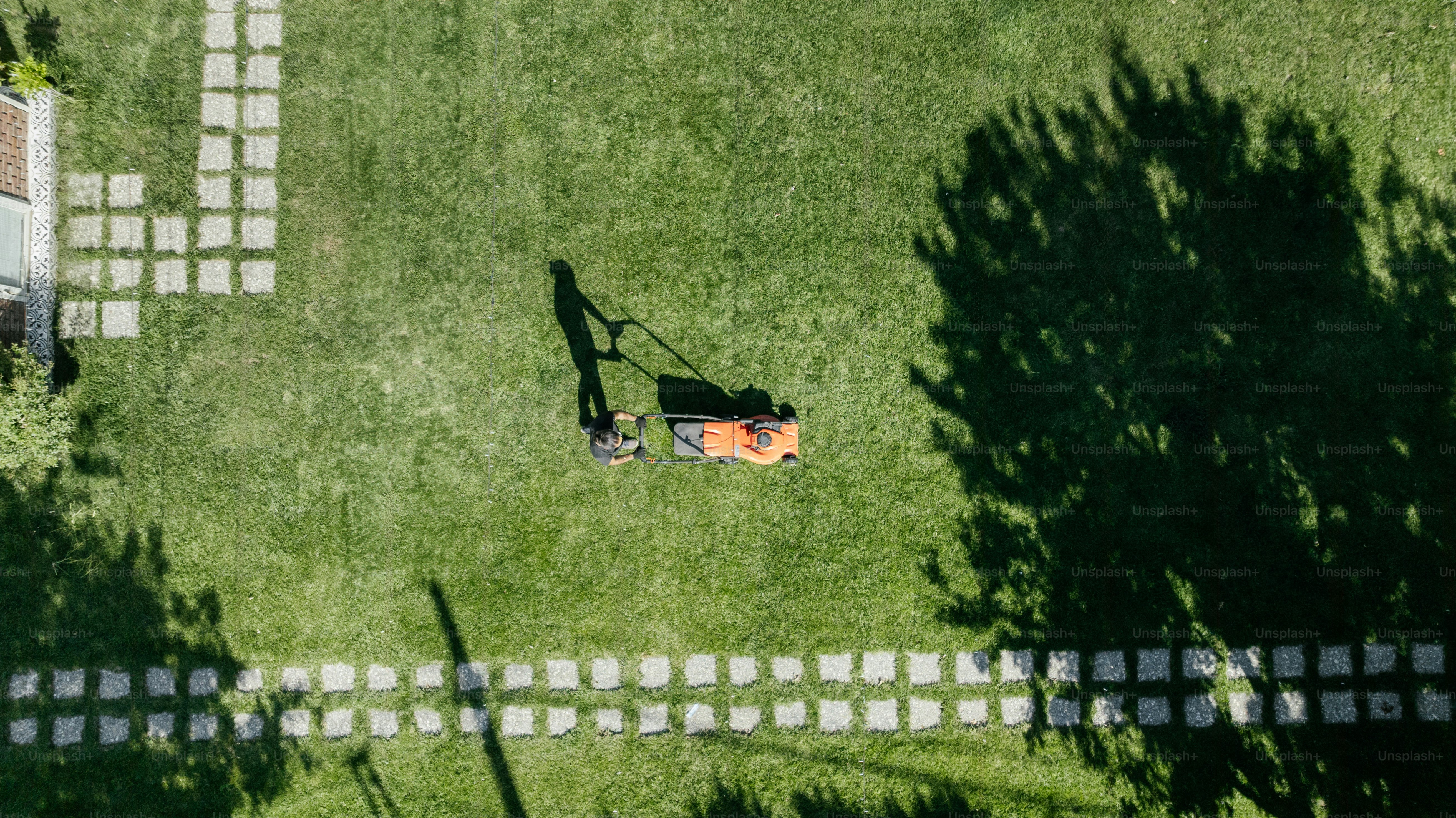 A person mows the lawn.