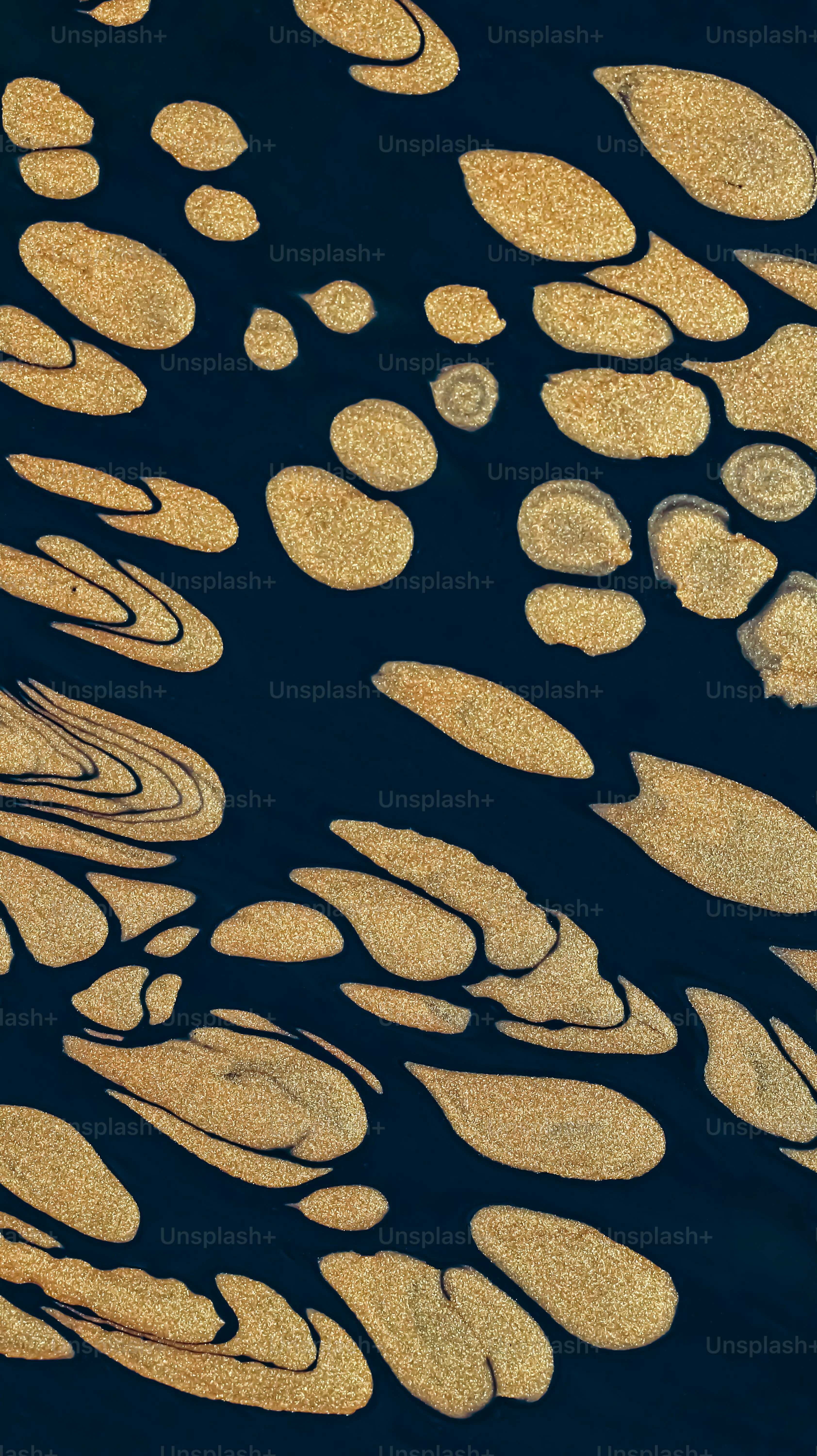 Abstract art with gold shapes on a dark background.