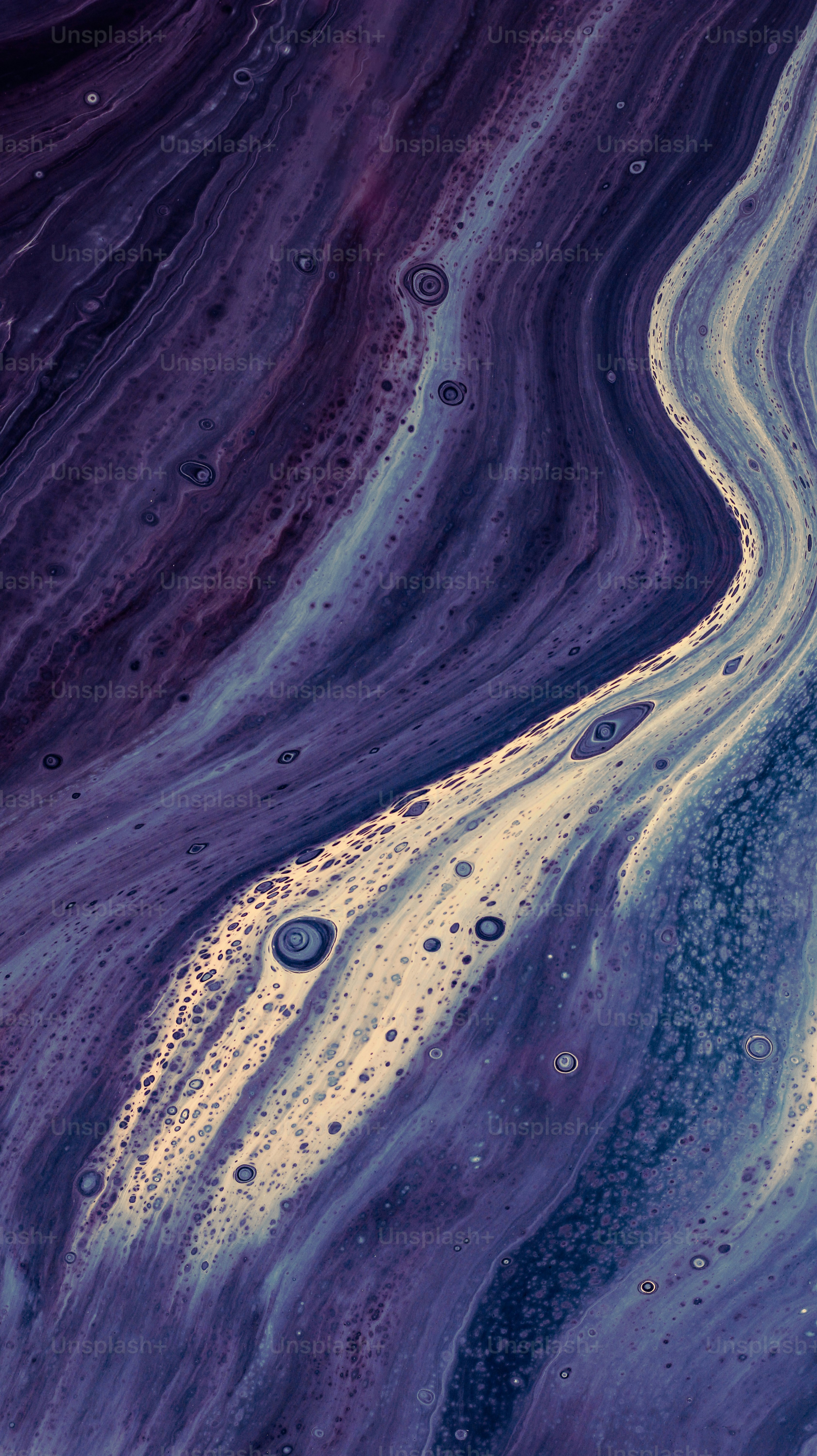 Abstract, flowing colors of purple and beige.