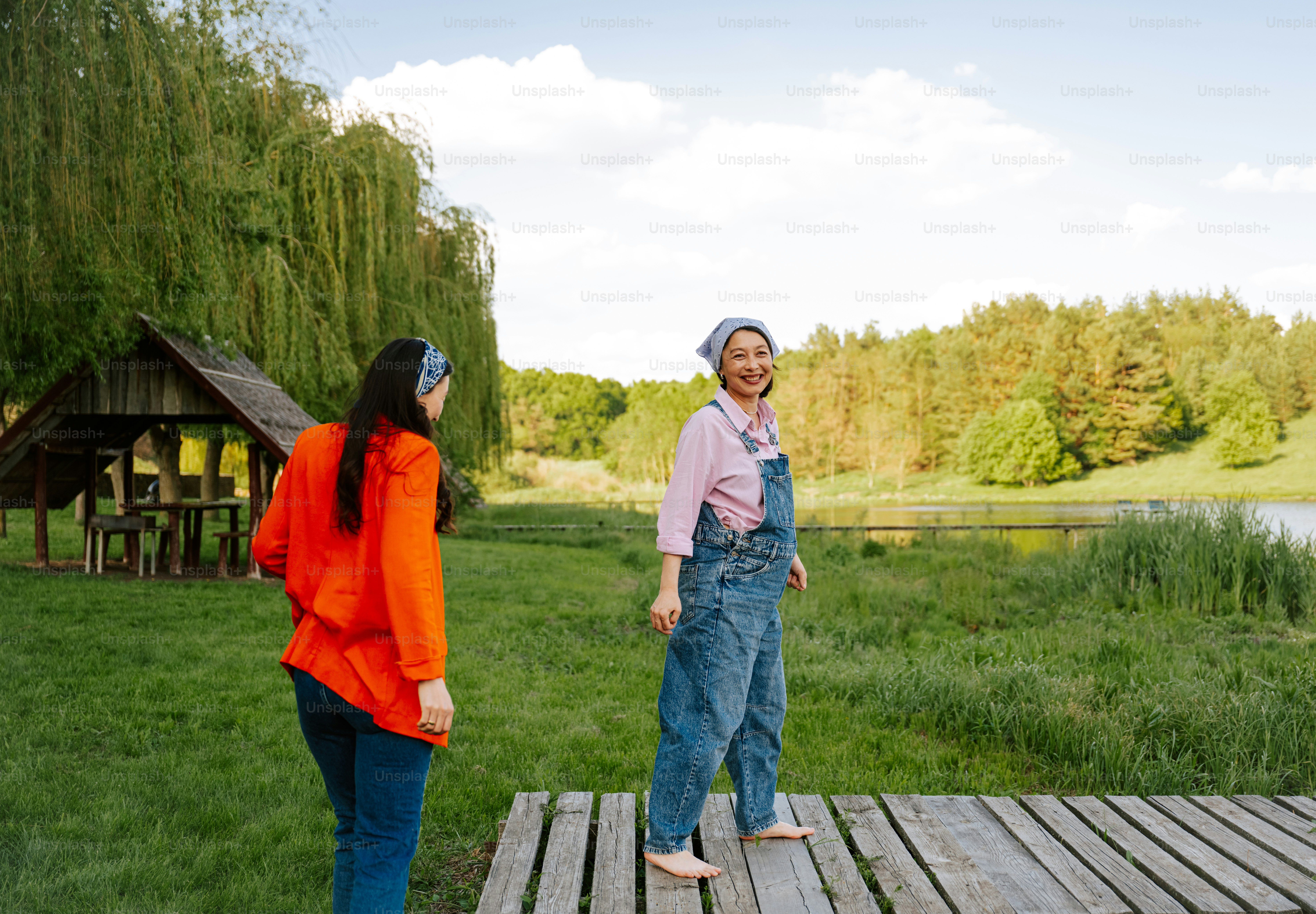 Two women are enjoying a day by the lake.