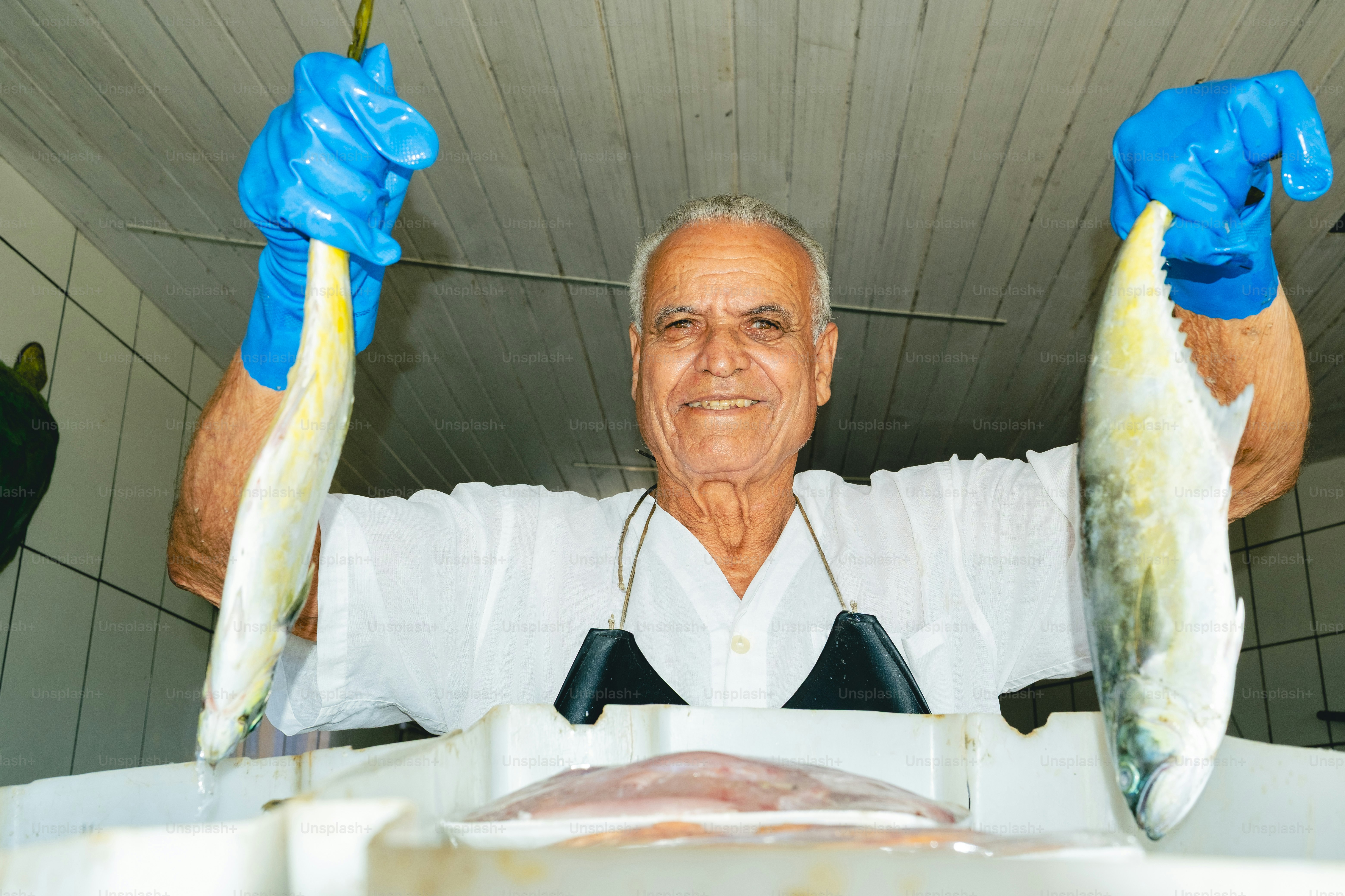 Fisherman proudly displays freshly caught fish.
