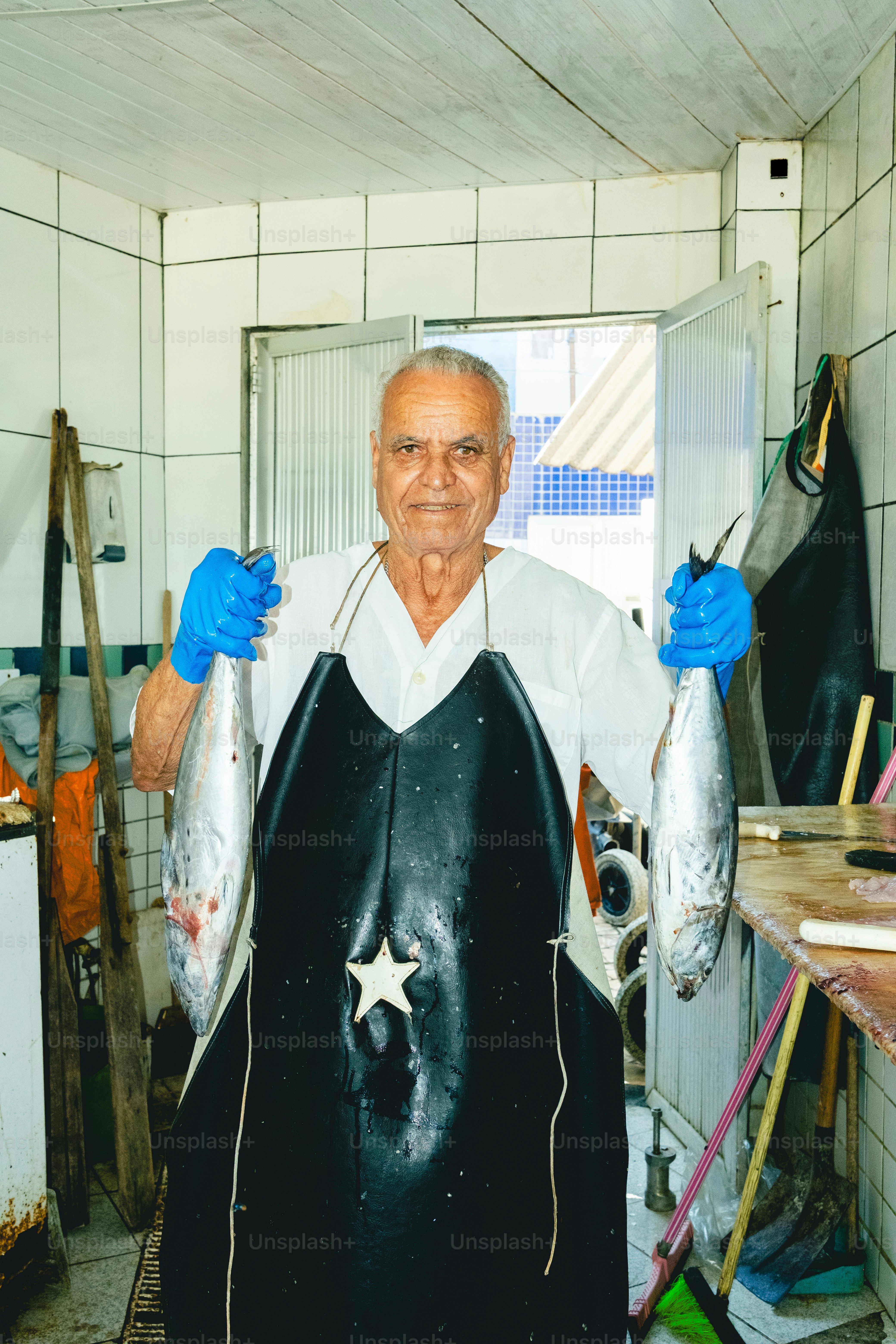 Fisherman proudly displays freshly caught fish.