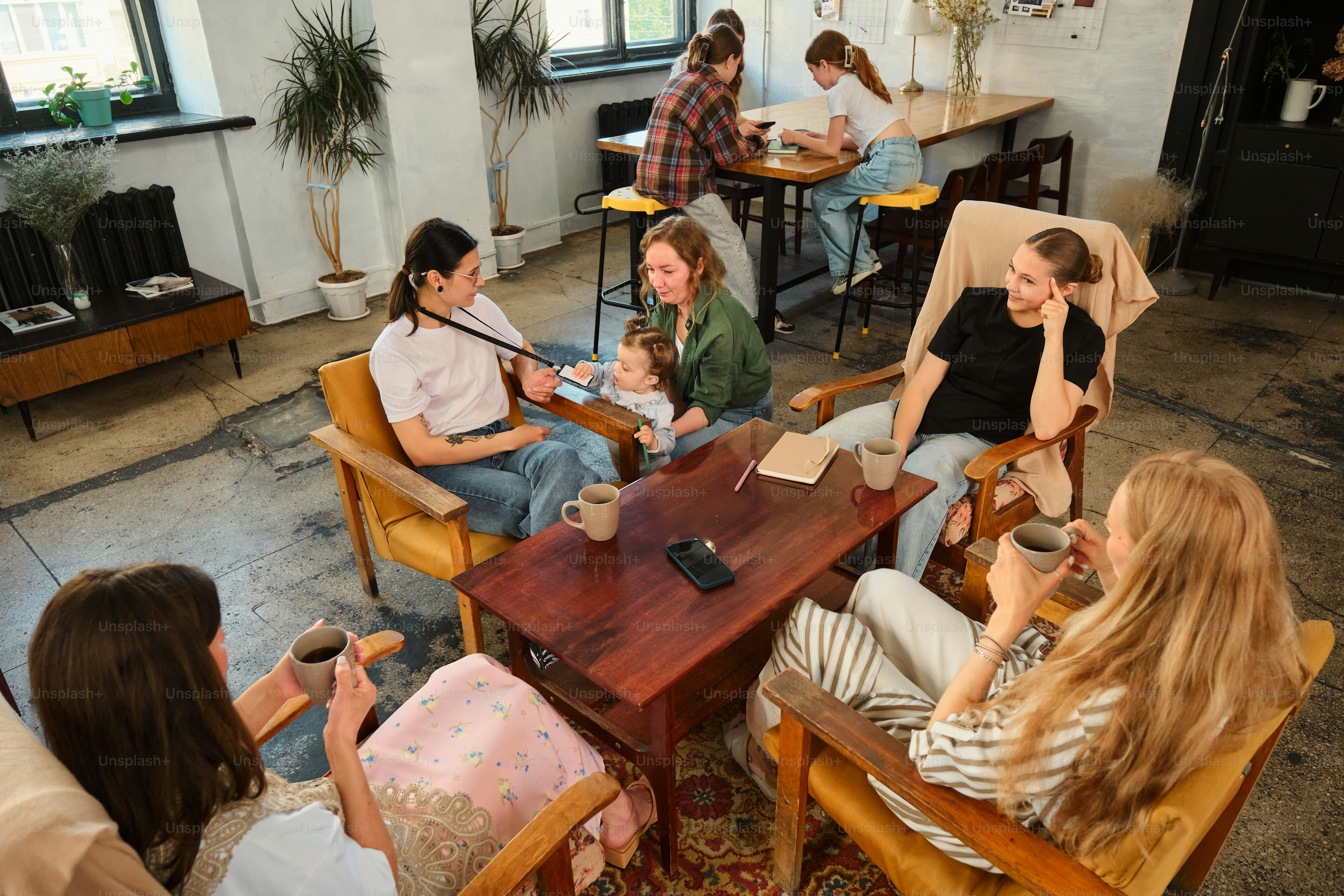People socialize in a cafe, drinking coffee.