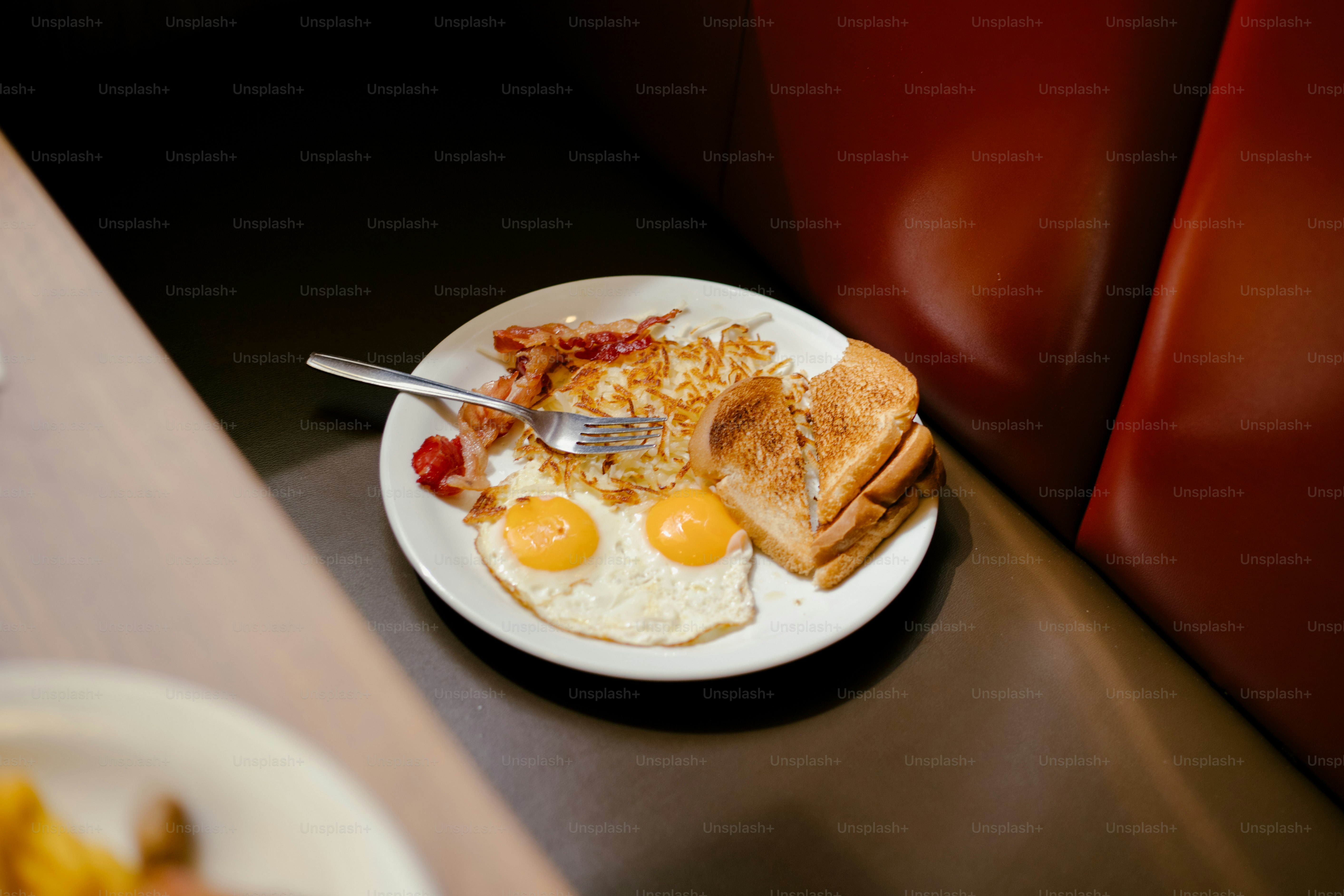 Breakfast is served with eggs, toast, and hash browns