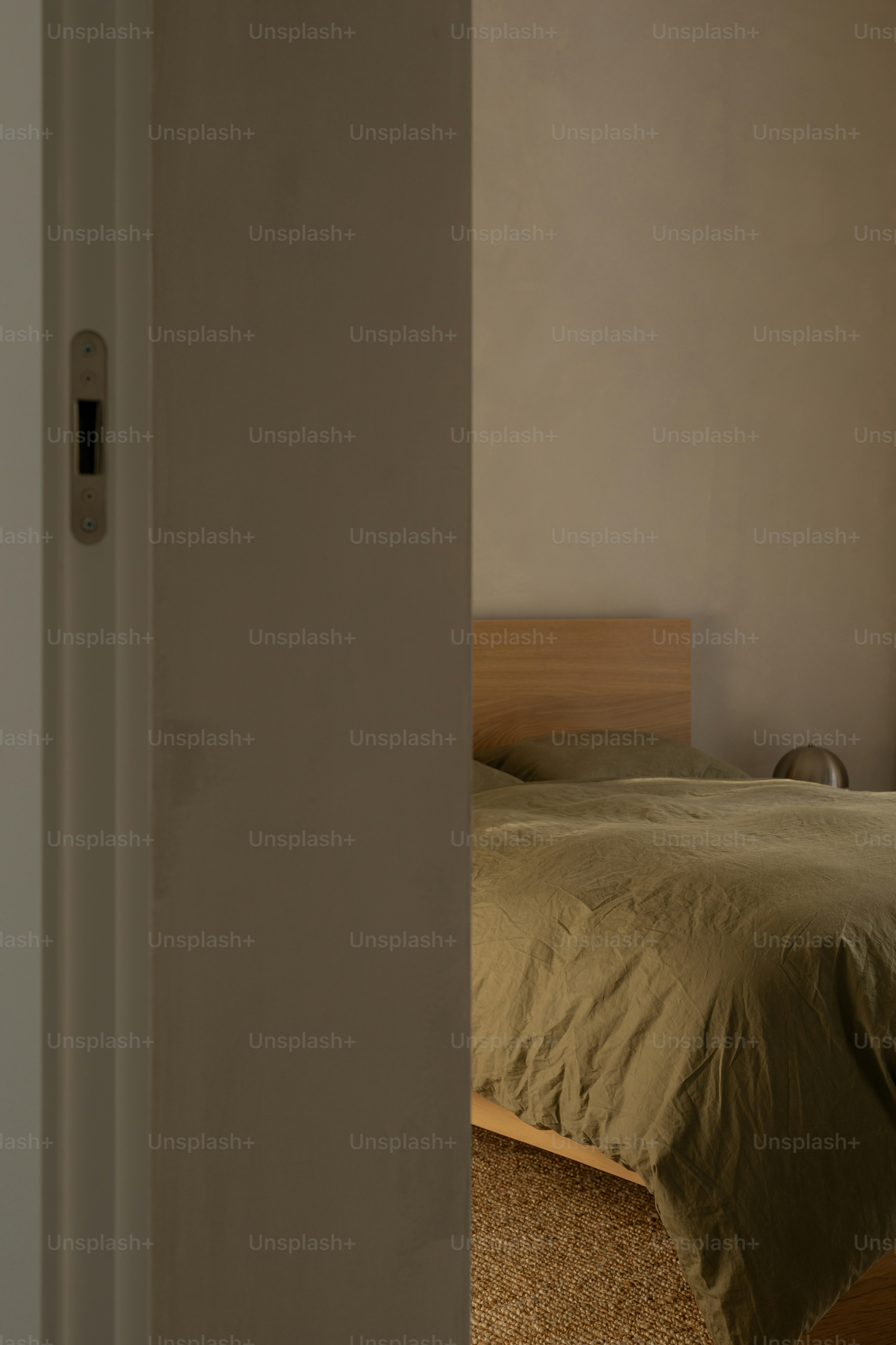 A glimpse of a bedroom with a bed.