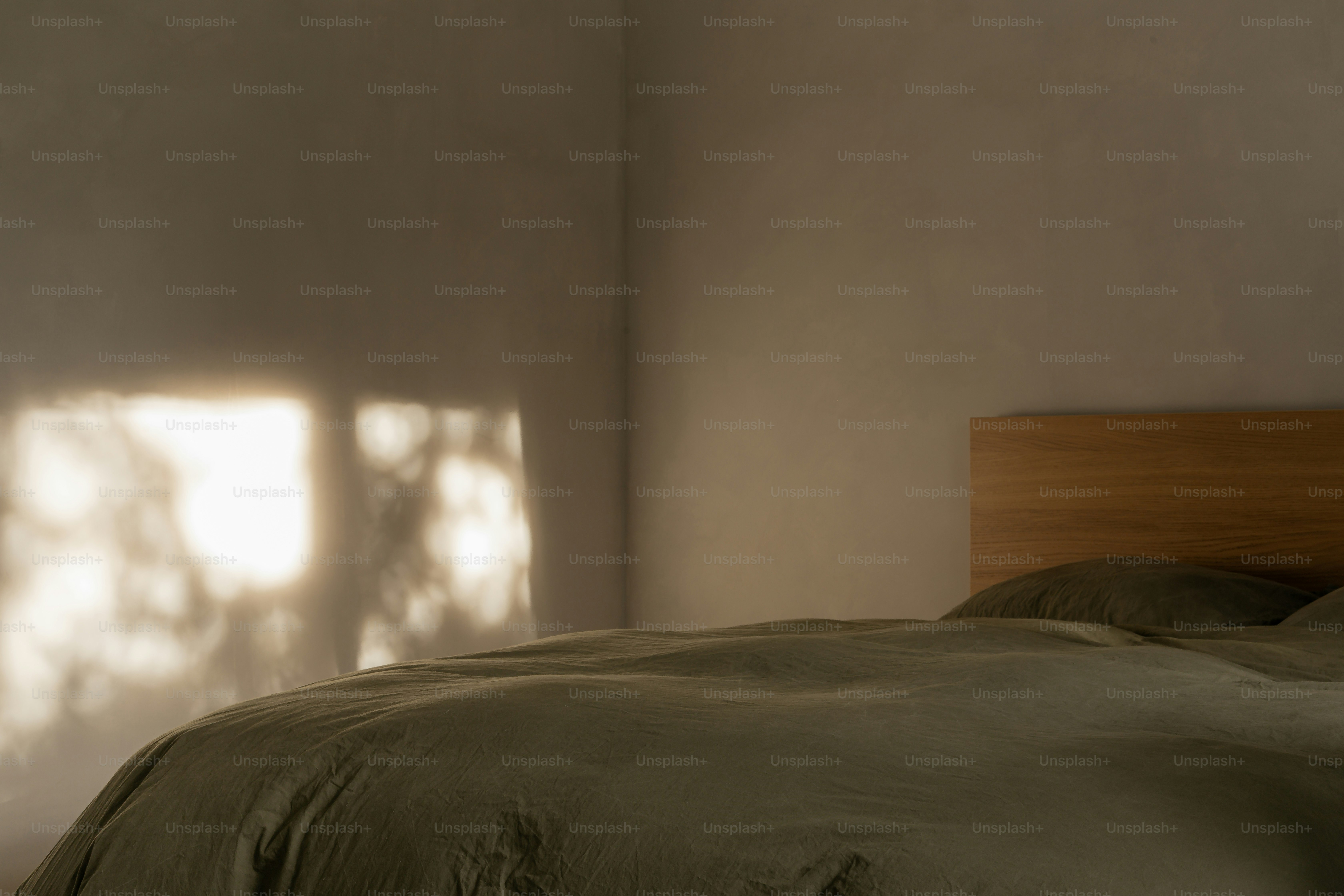 Sunlight streams into a simple bedroom.