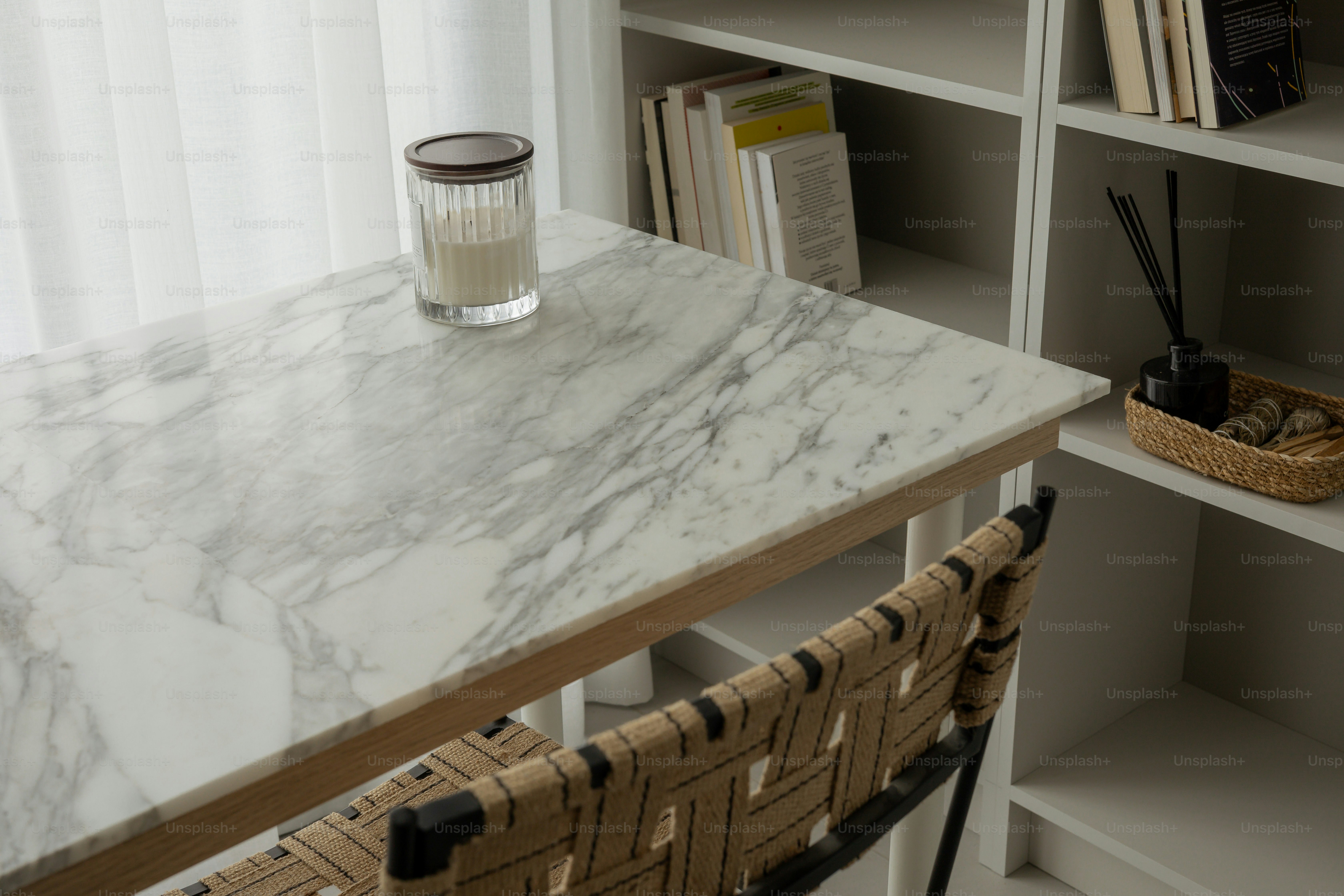 A marble desk with books and a candle.