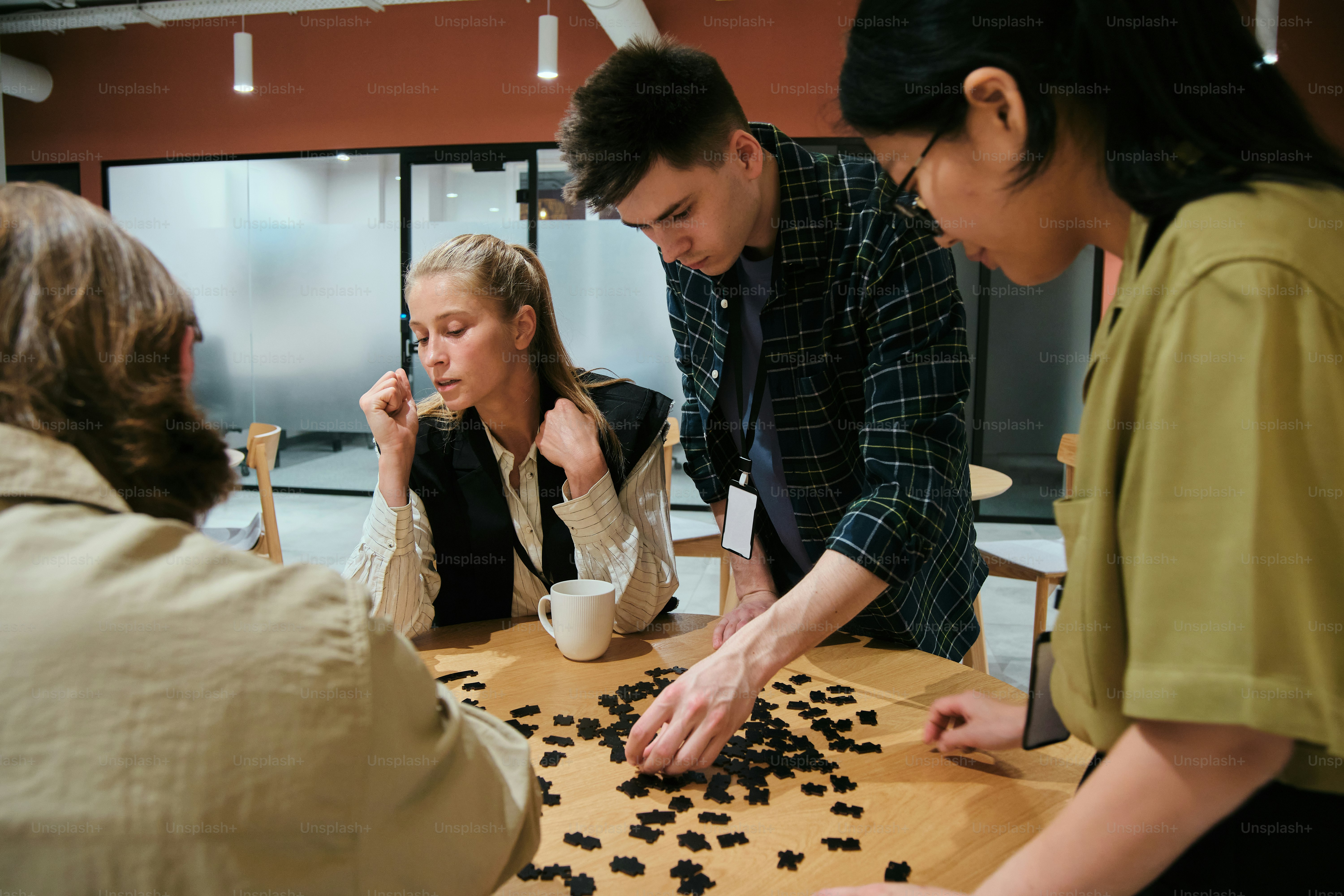 People work together, focusing on a board game. photo – Office Image on ...