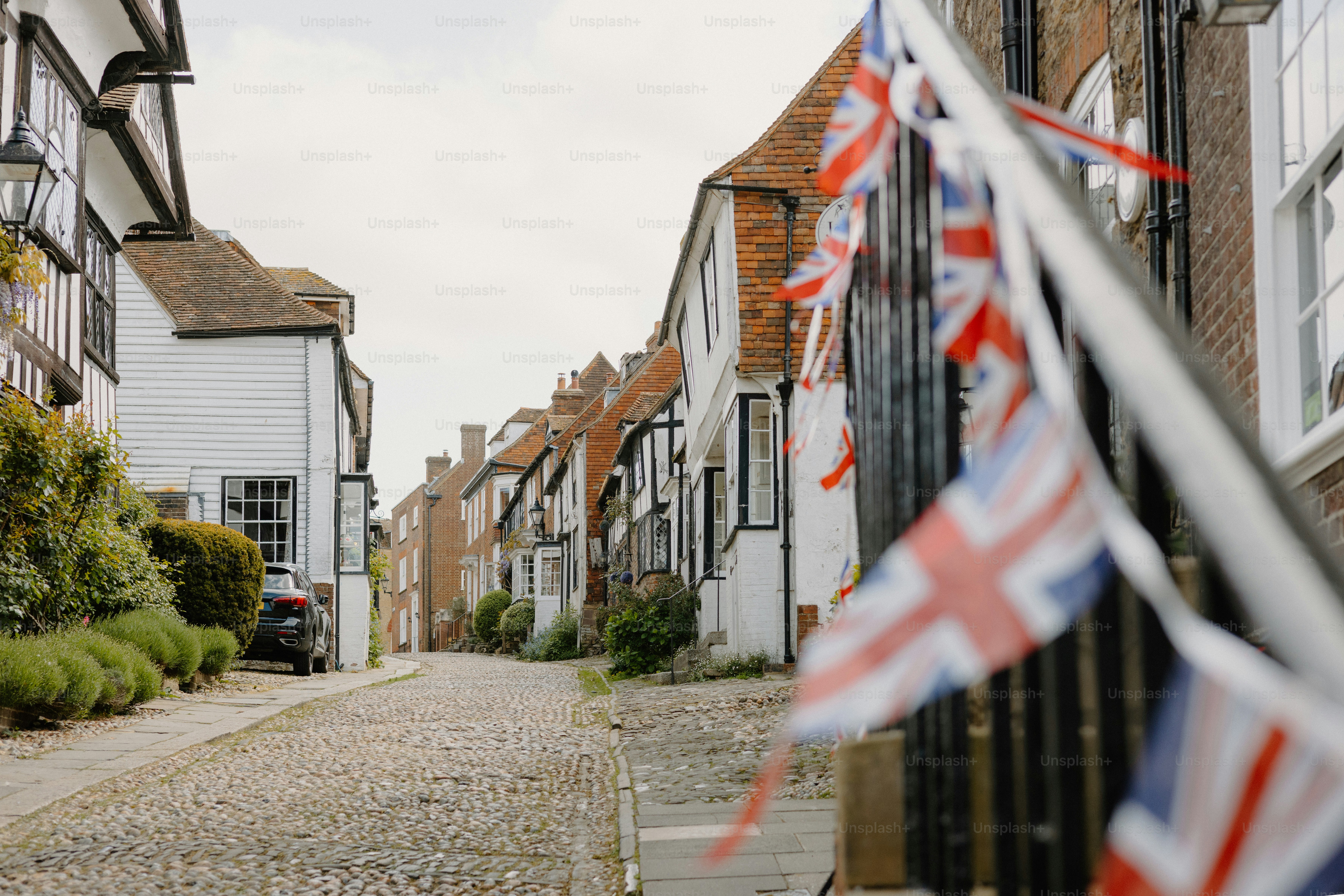 Quaint street adorned with british flags.
