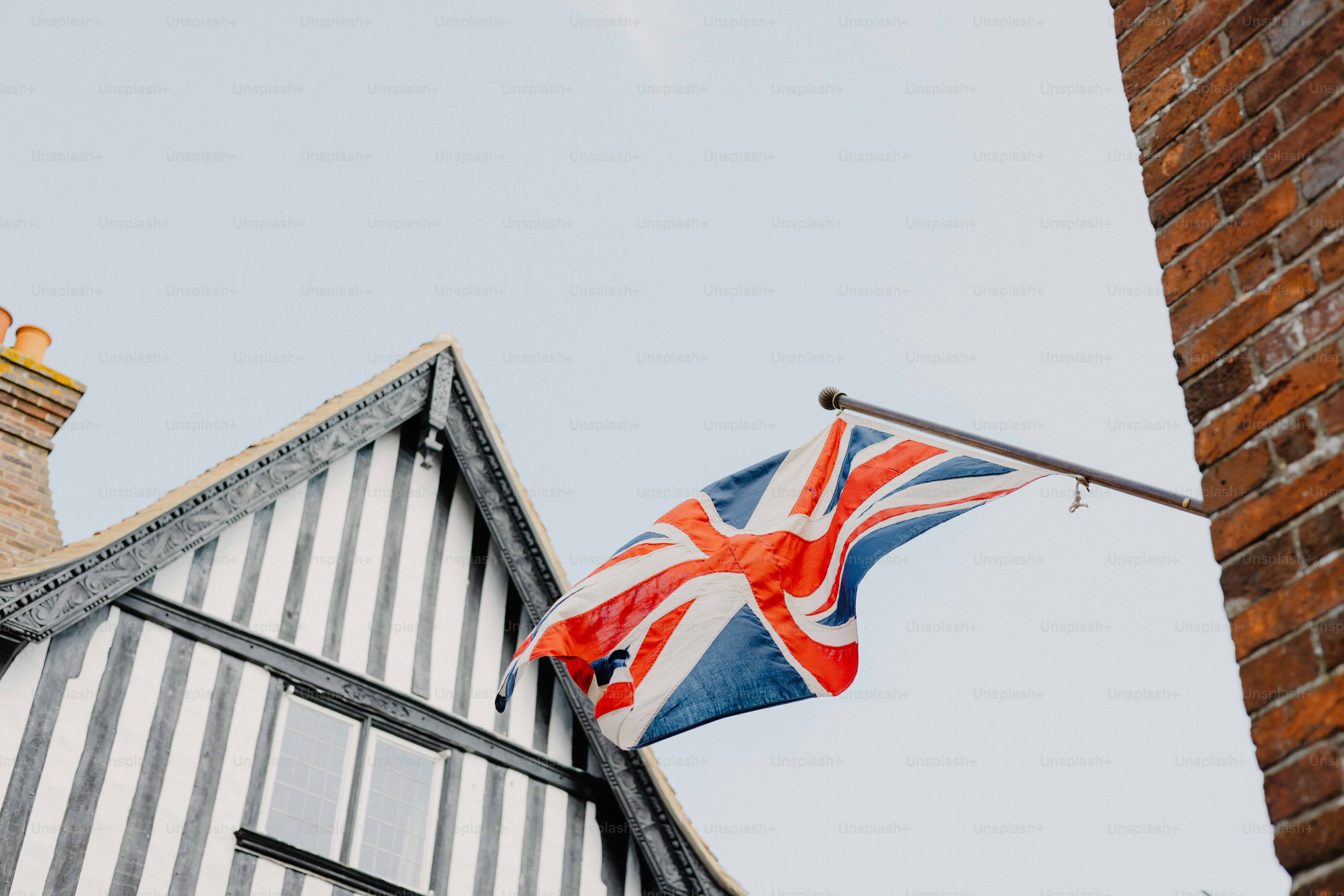 A union jack flag hangs on a building