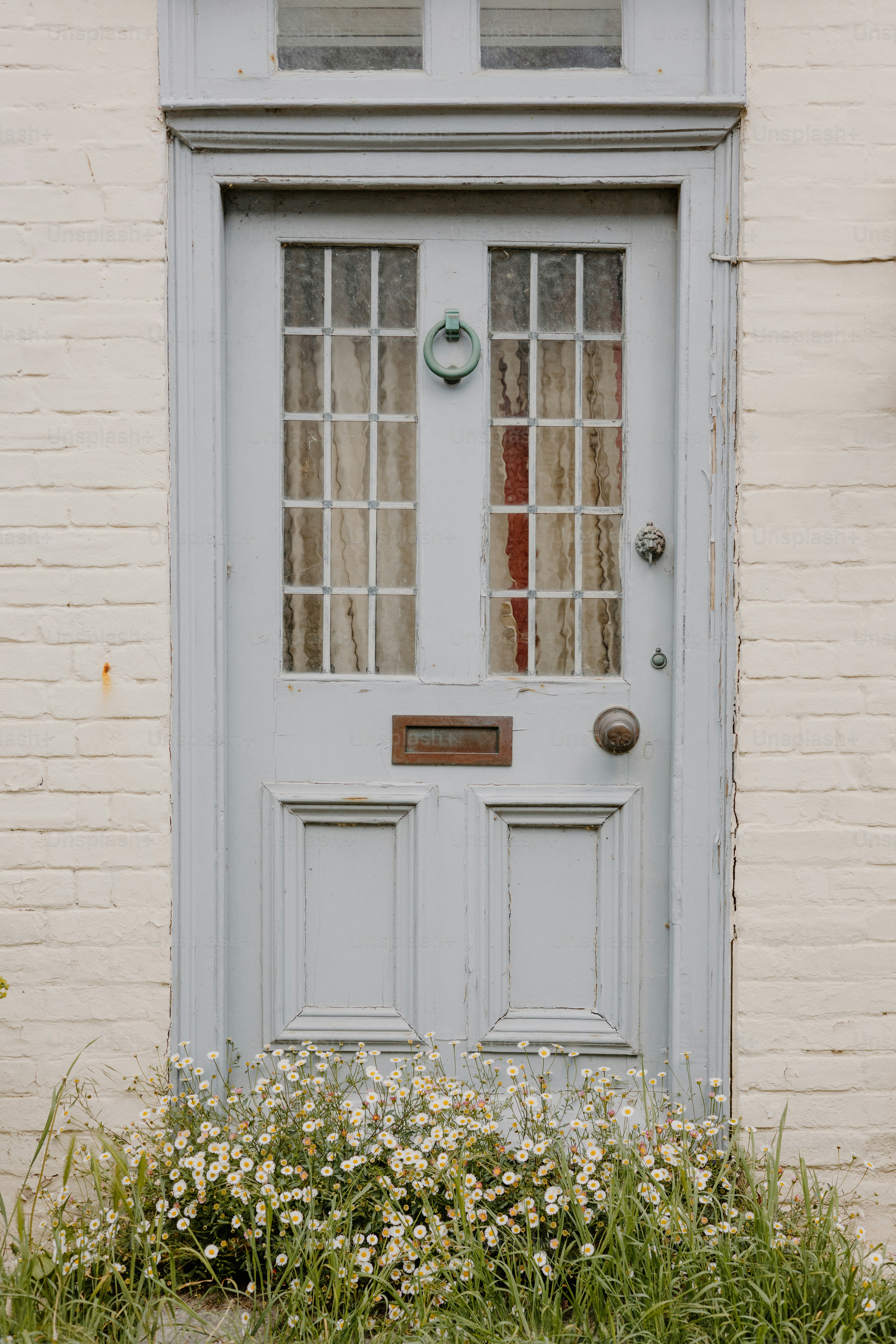 A charming blue door with floral embellishments.