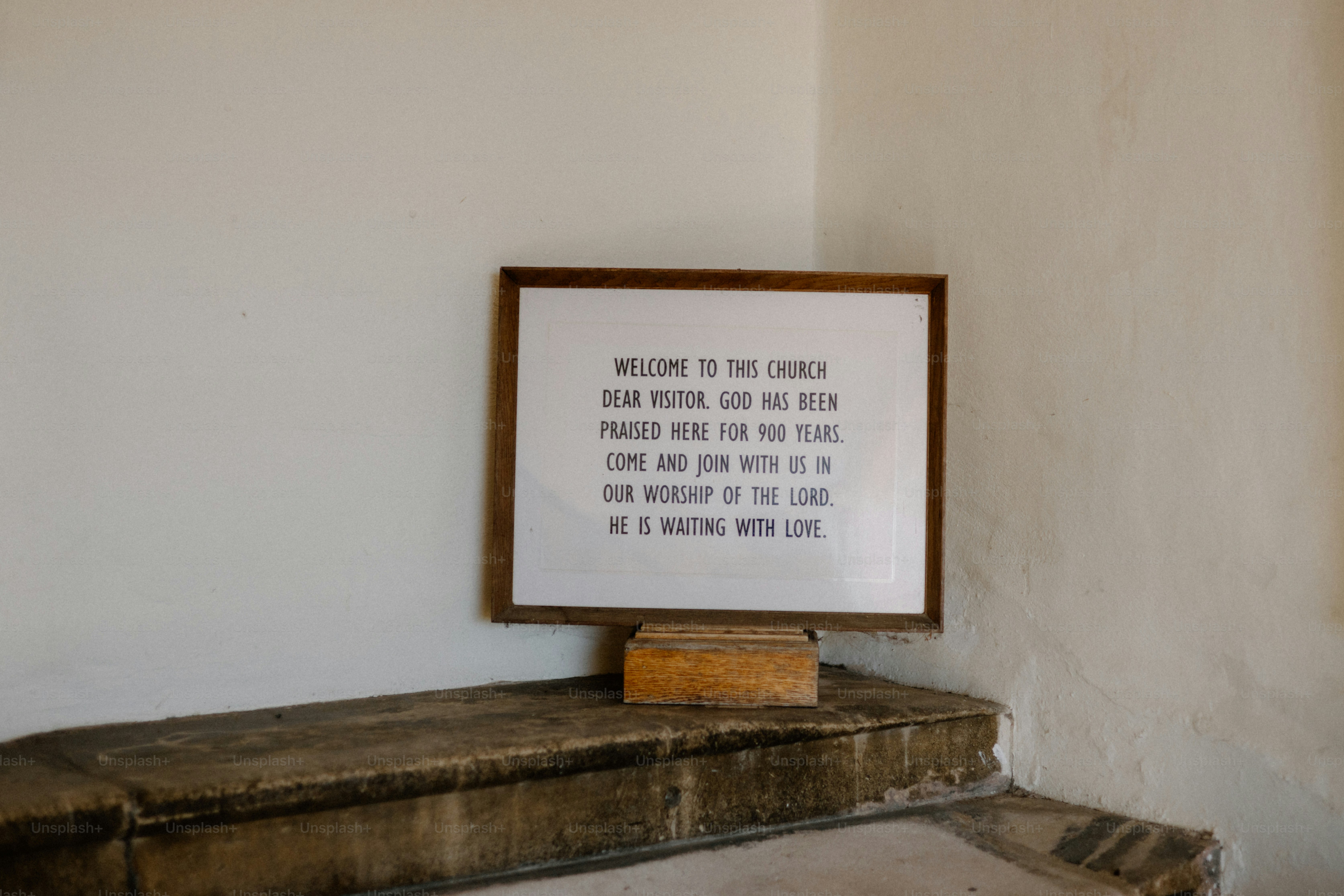A framed sign welcomes visitors to the church.