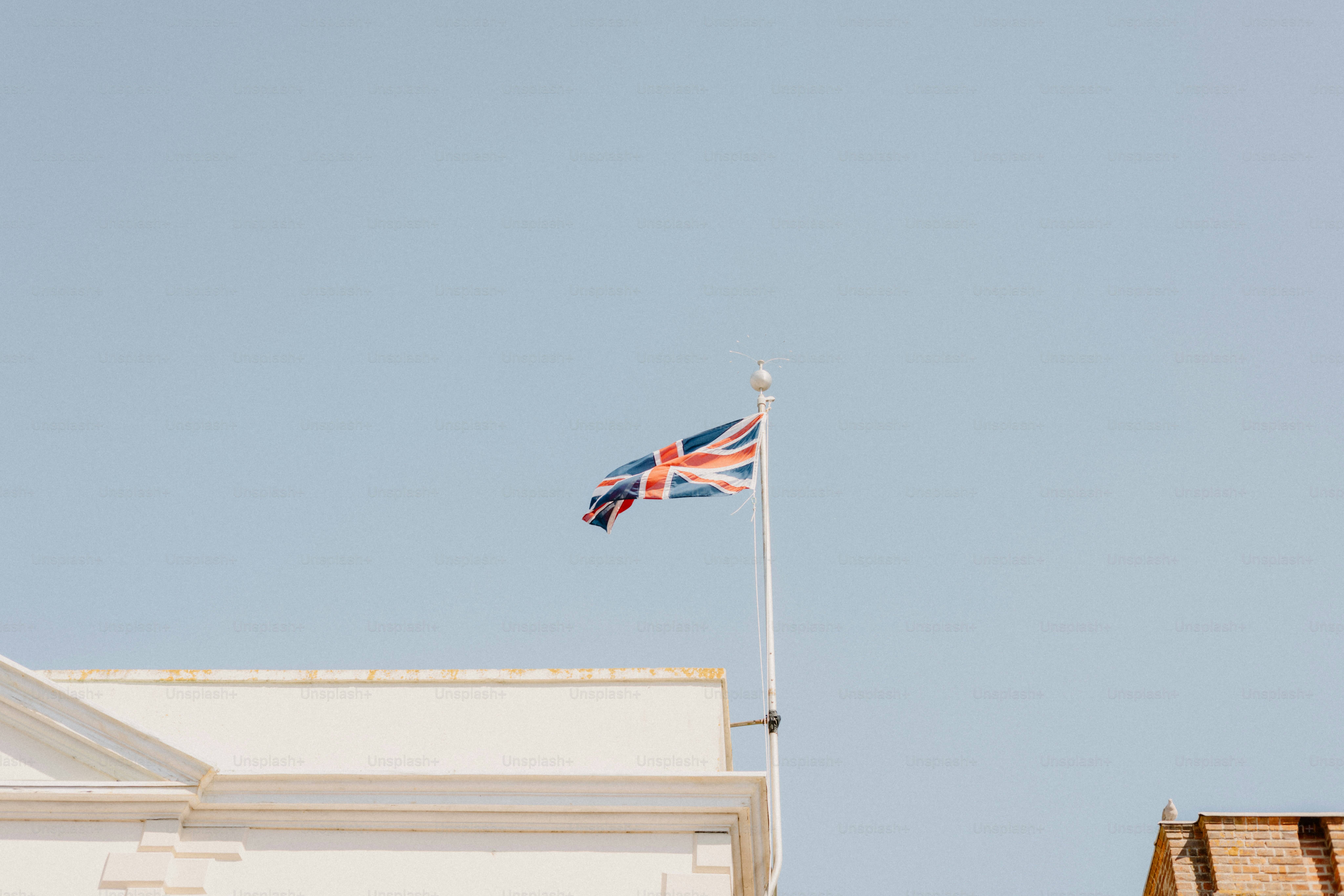 The british flag waves proudly in the sky.