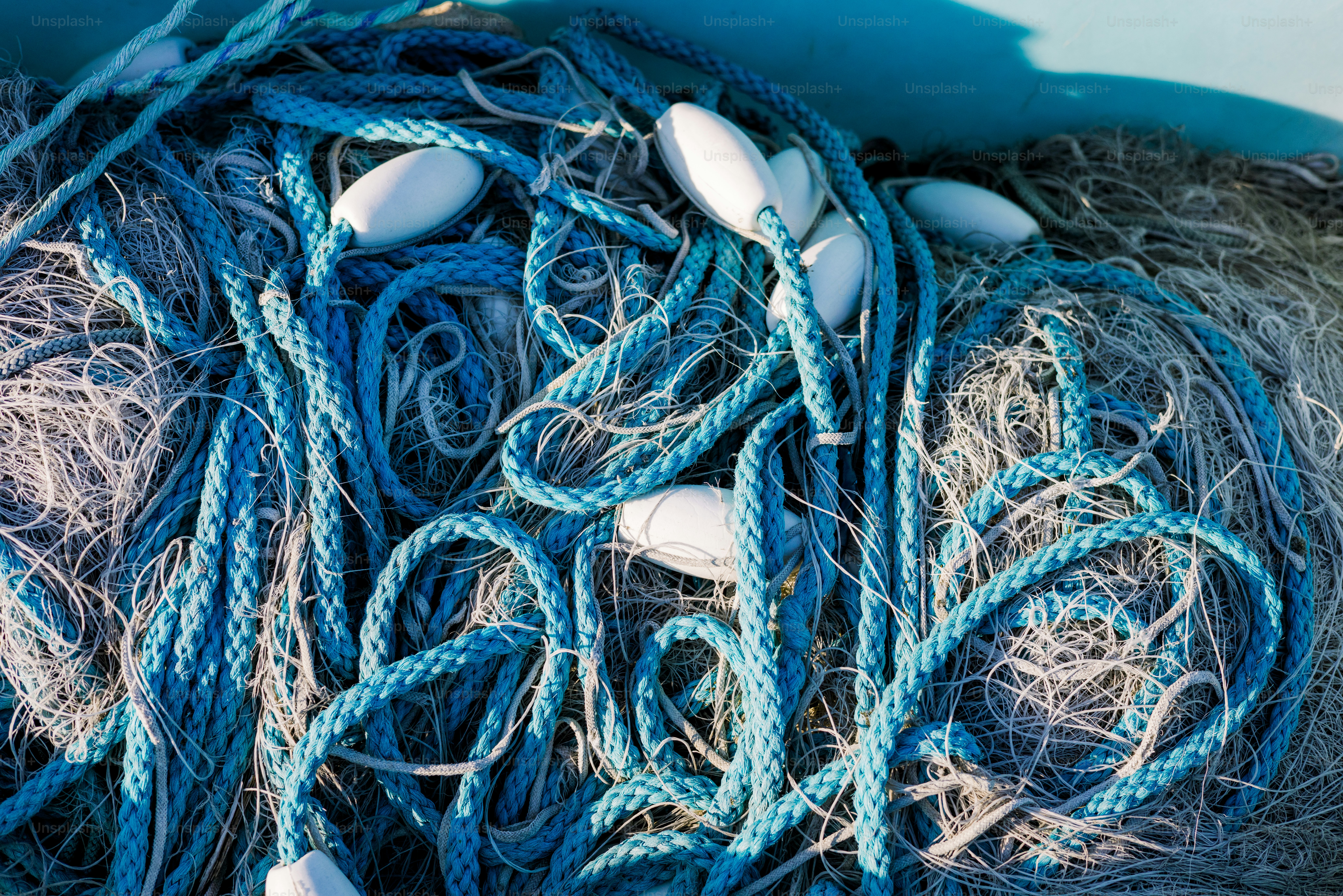 Fishing net with blue ropes and white floats. photo  Blue Image on Unsplash