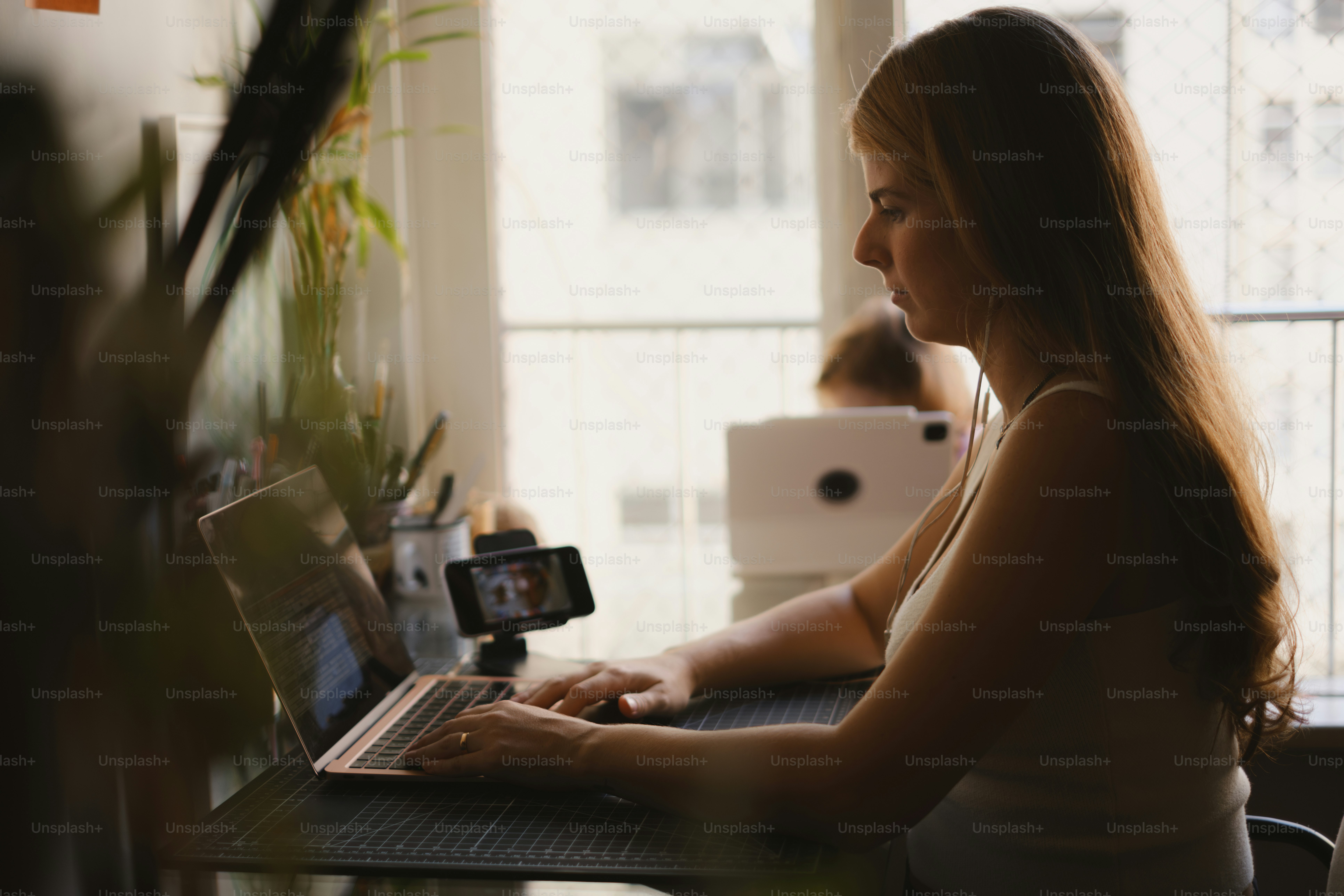 Woman works from home at her desk.