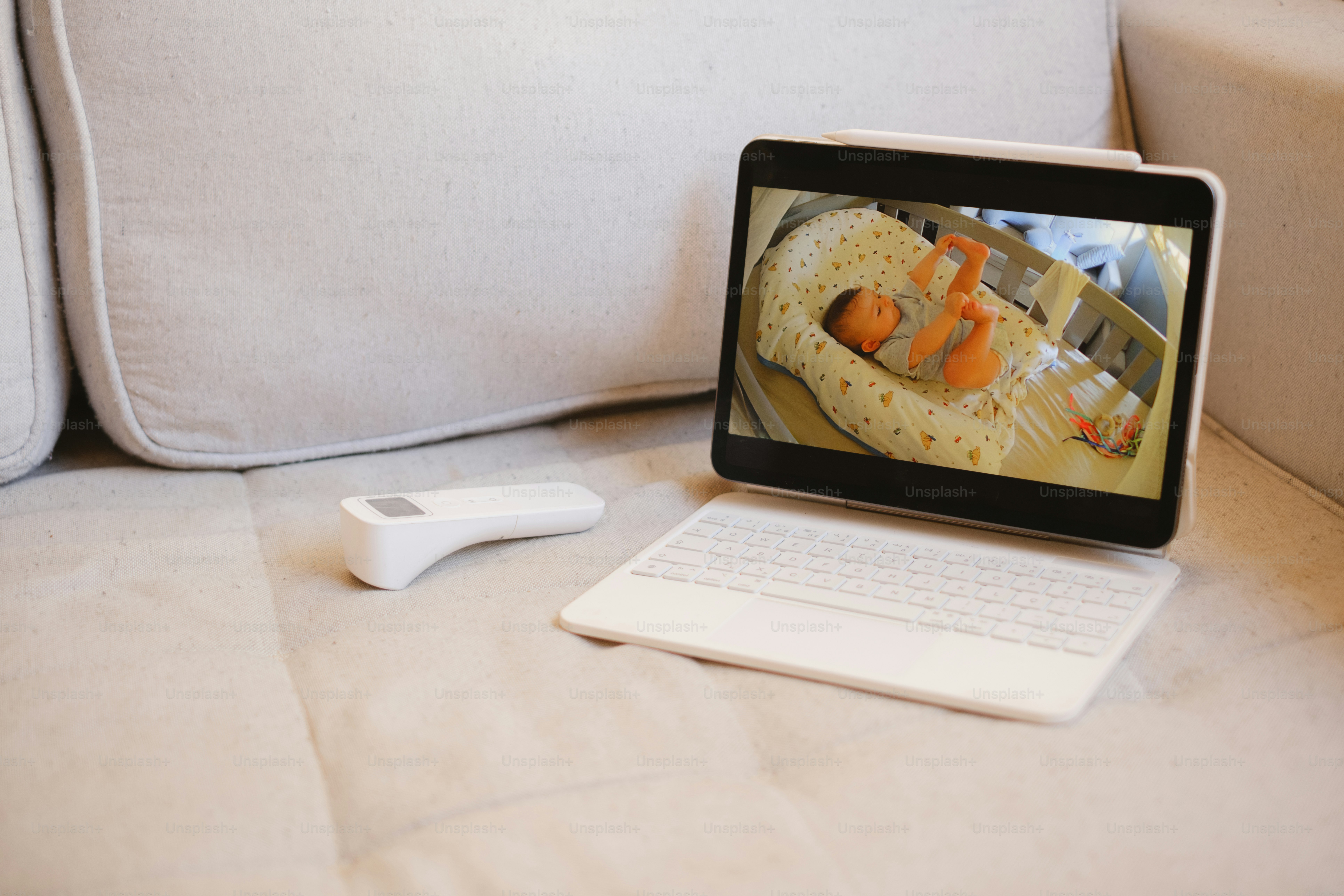 A tablet displays a baby monitor feed.