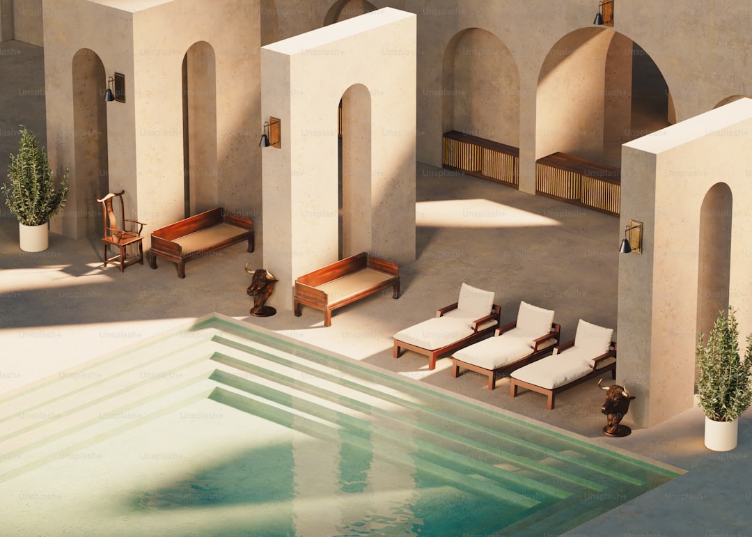 A stylish pool area with loungers and arches.