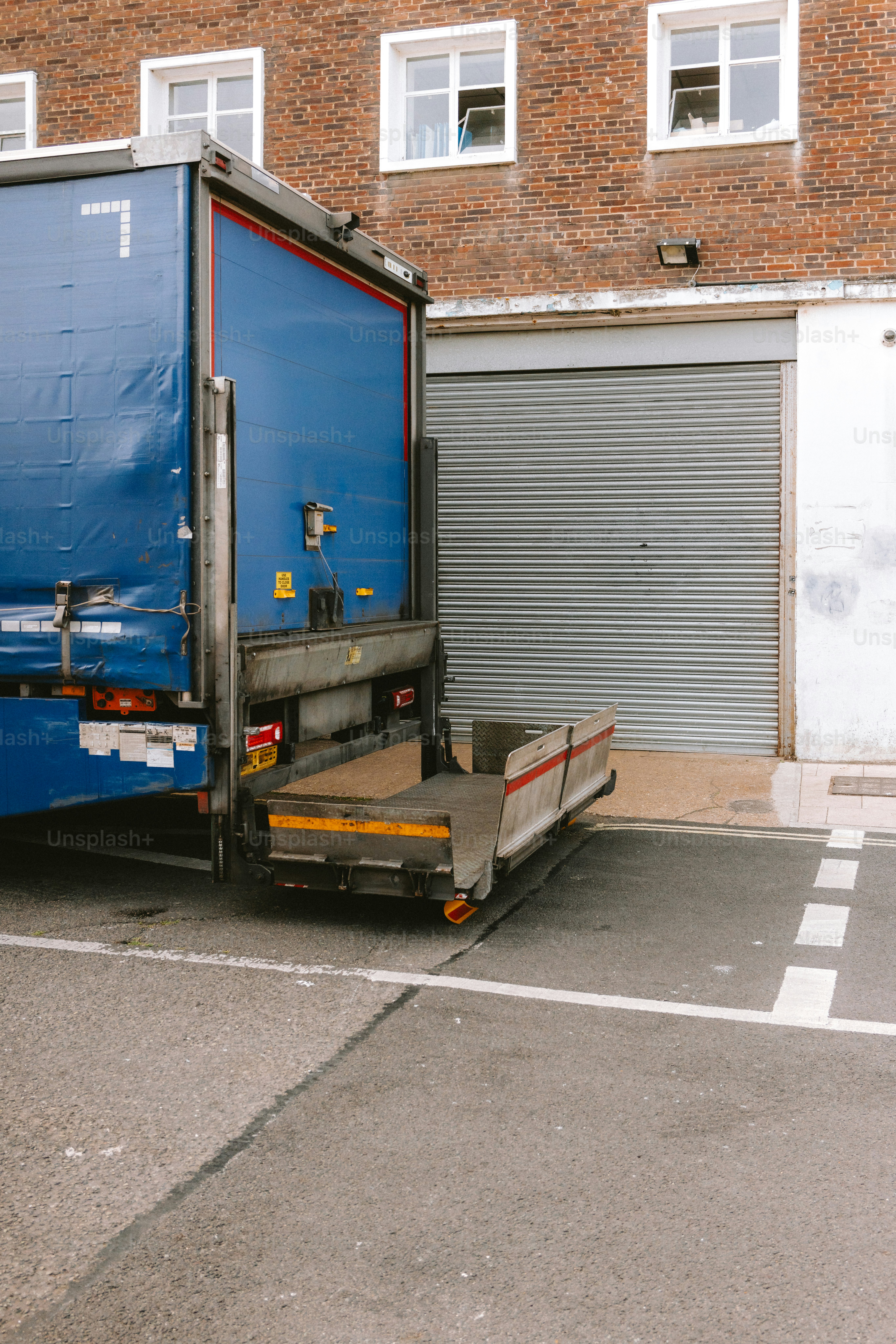 A delivery truck is parked at a loading dock.