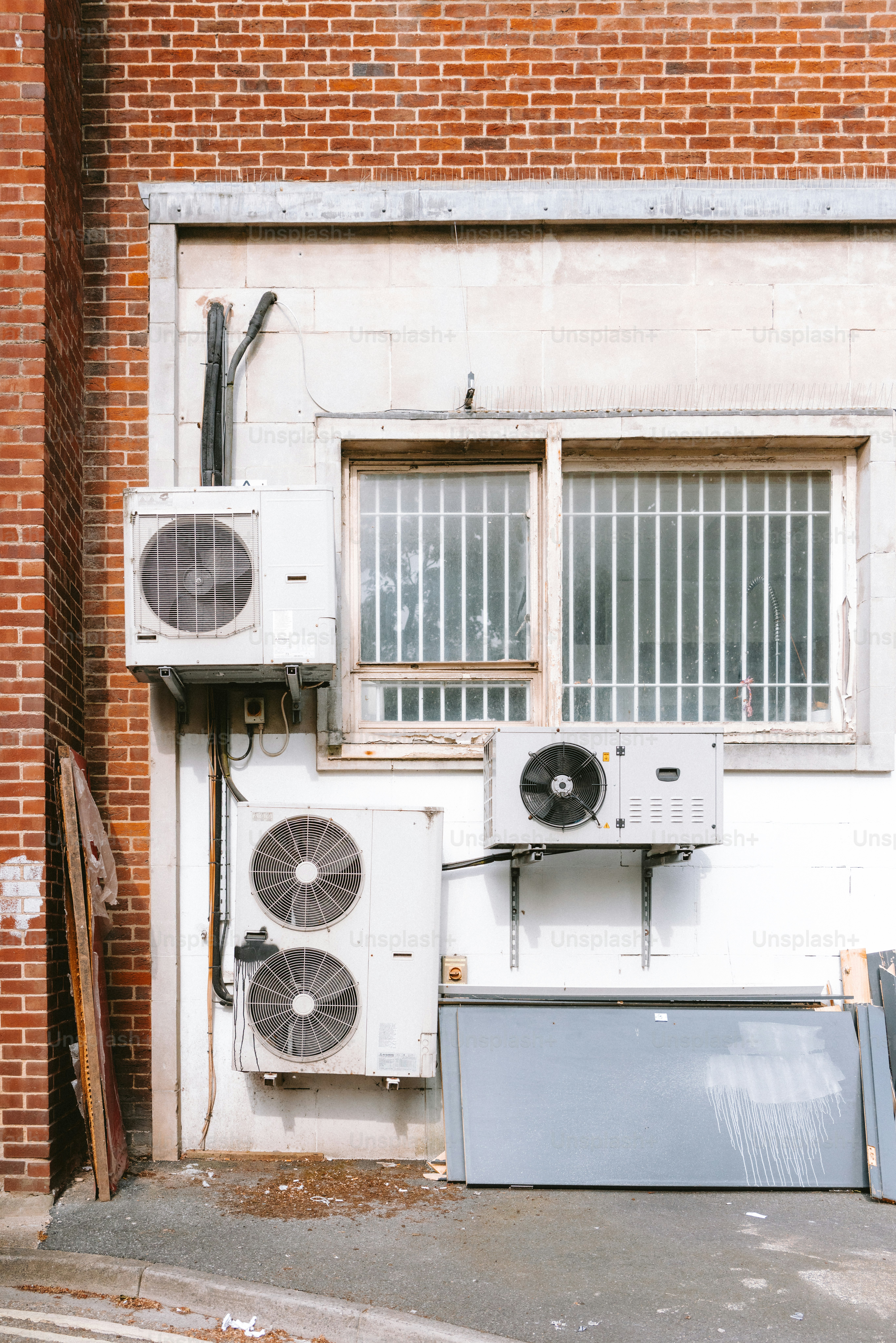 Air conditioners are affixed to a building's exterior.