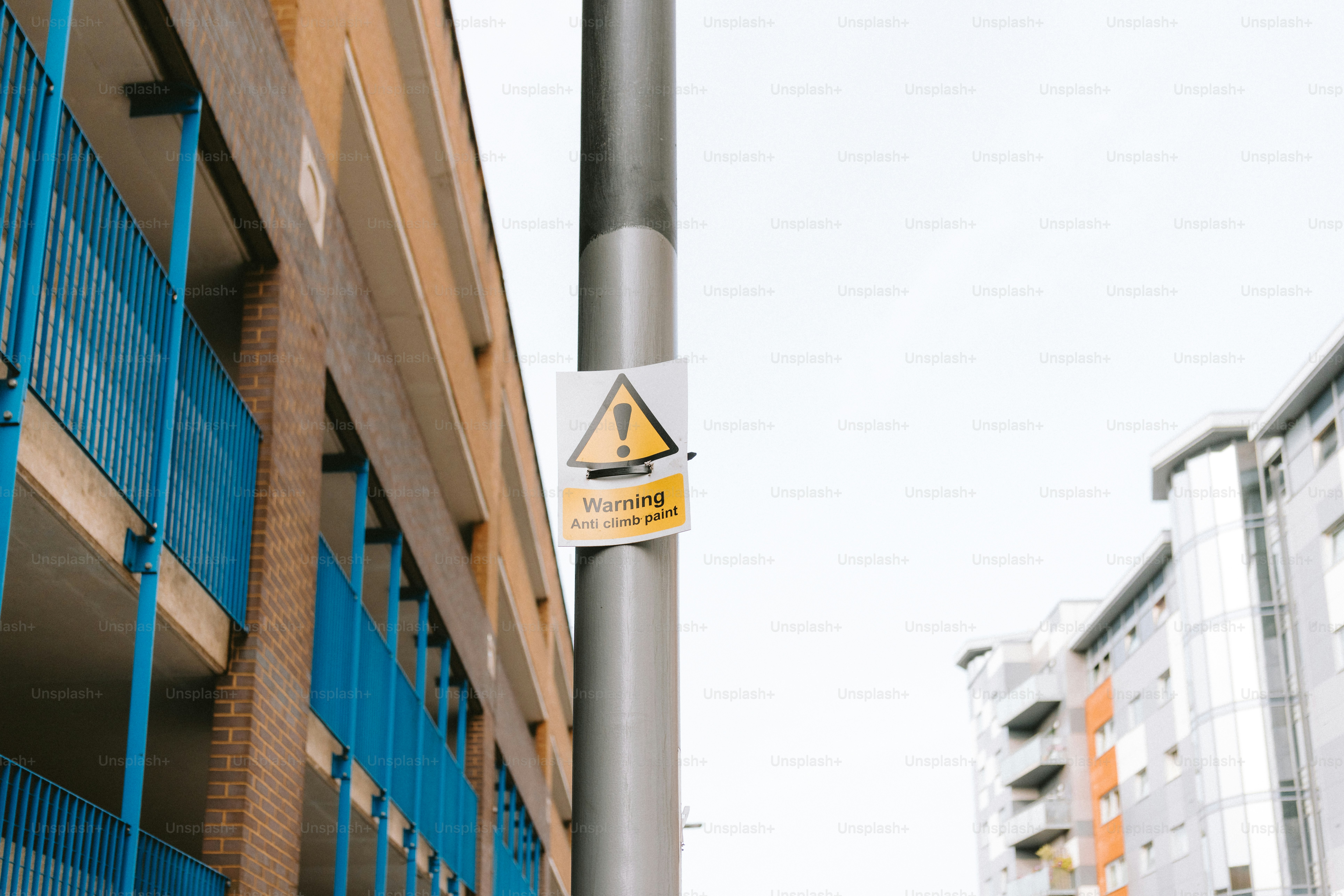 A warning sign is attached to a pole.