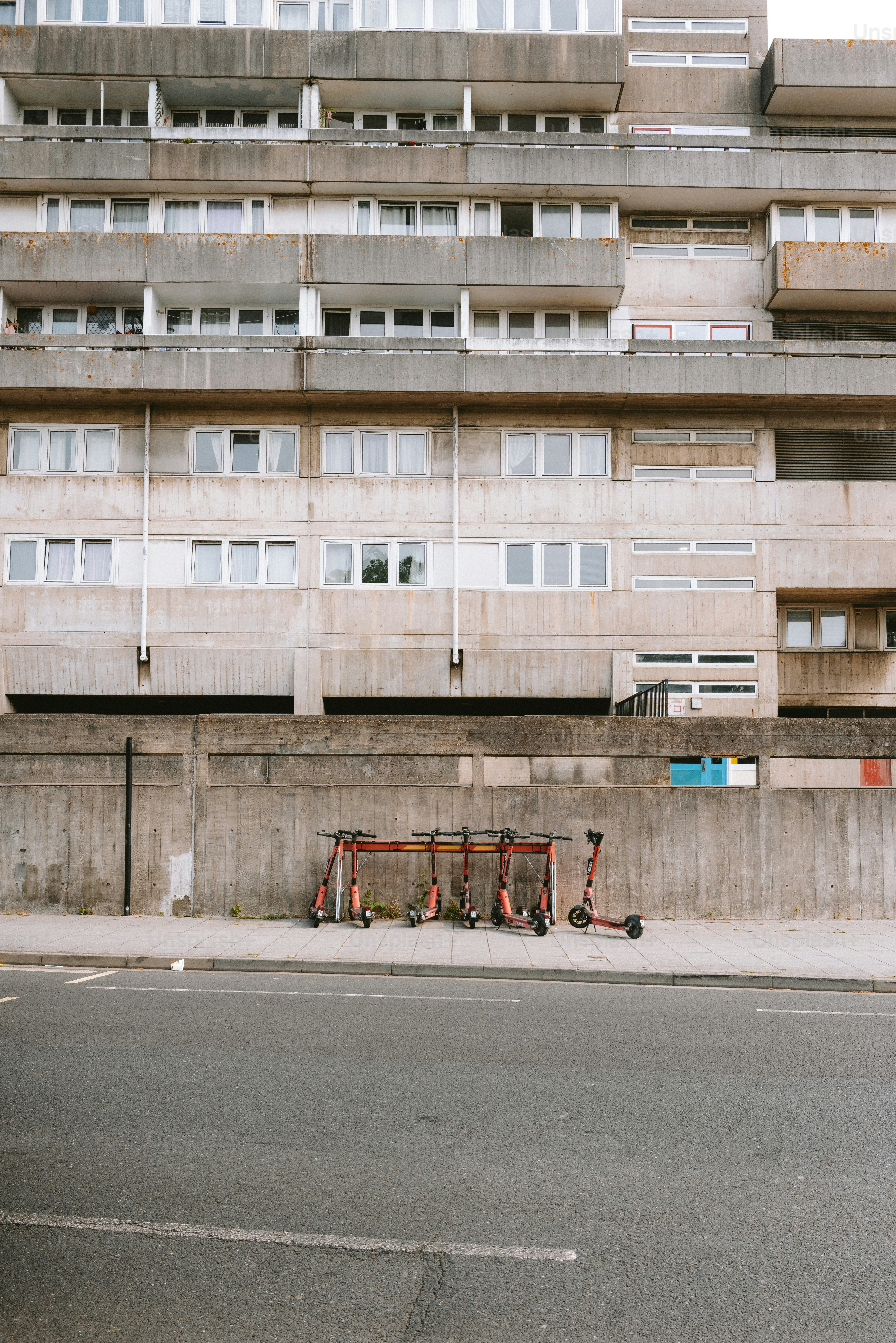 Concrete building and parked electric scooters.