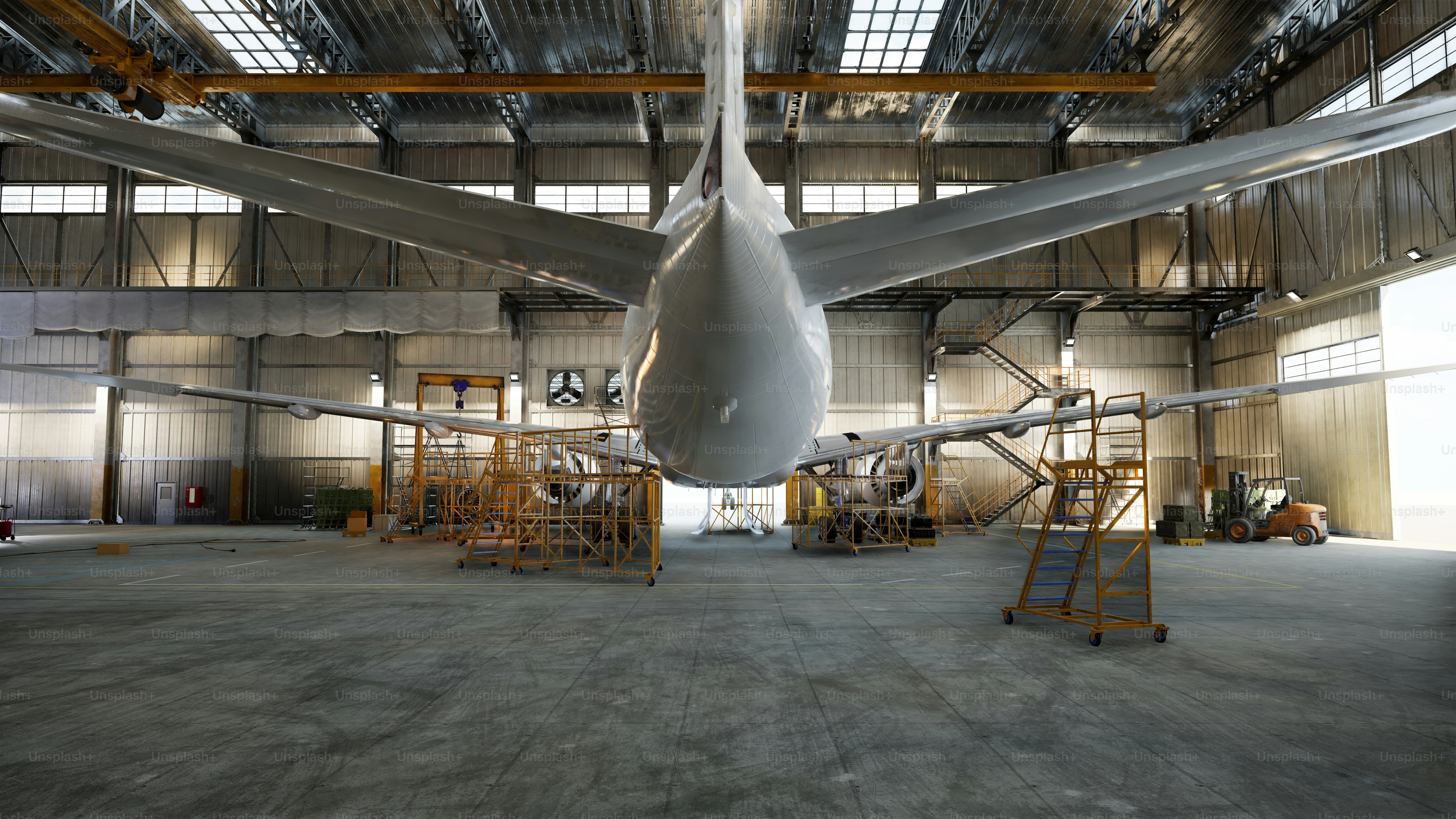Airplane inside a hangar being worked on.