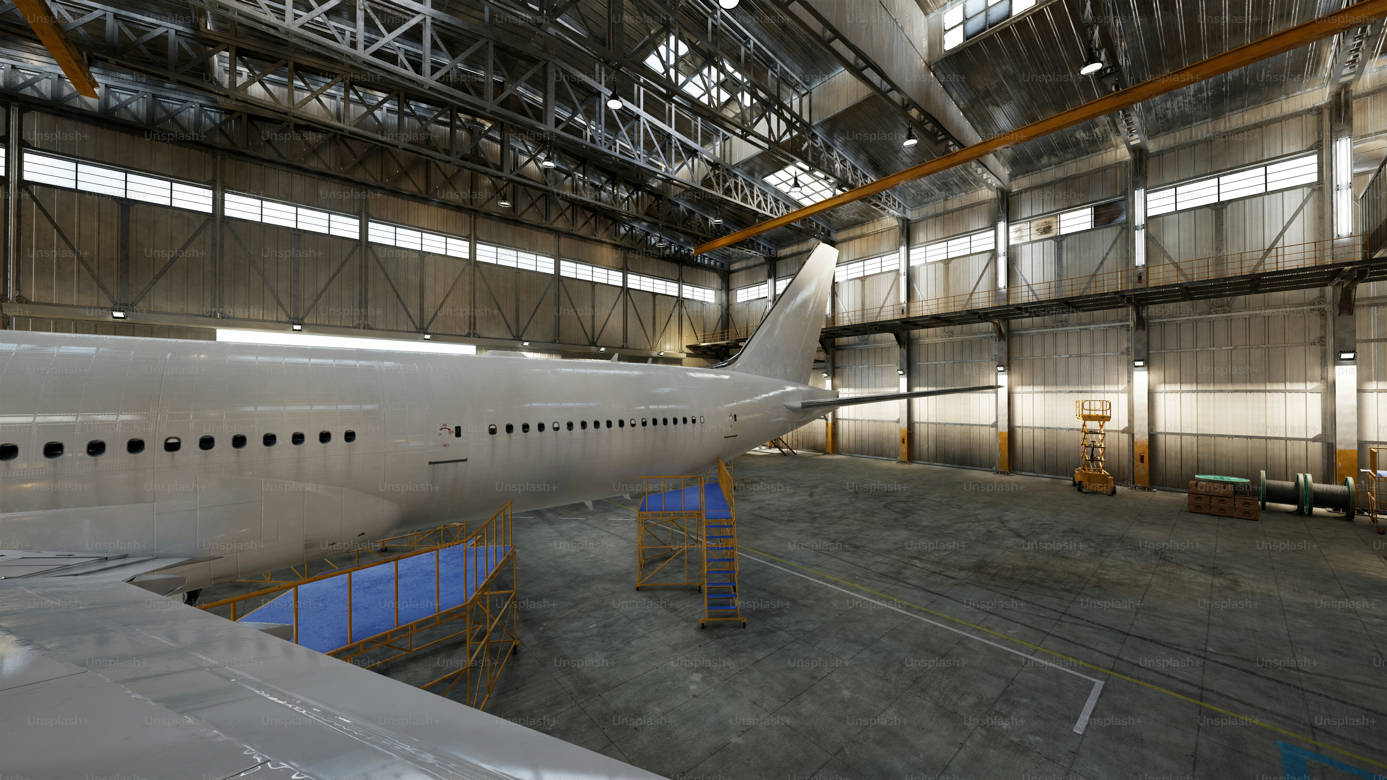 An airplane is inside a spacious hangar.