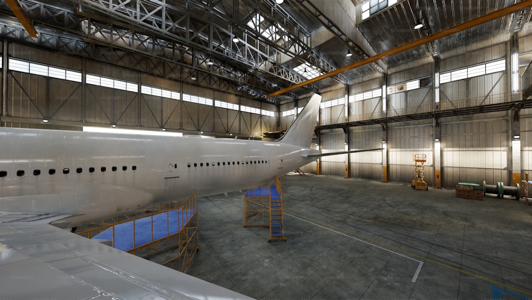 An airplane is inside a spacious hangar.