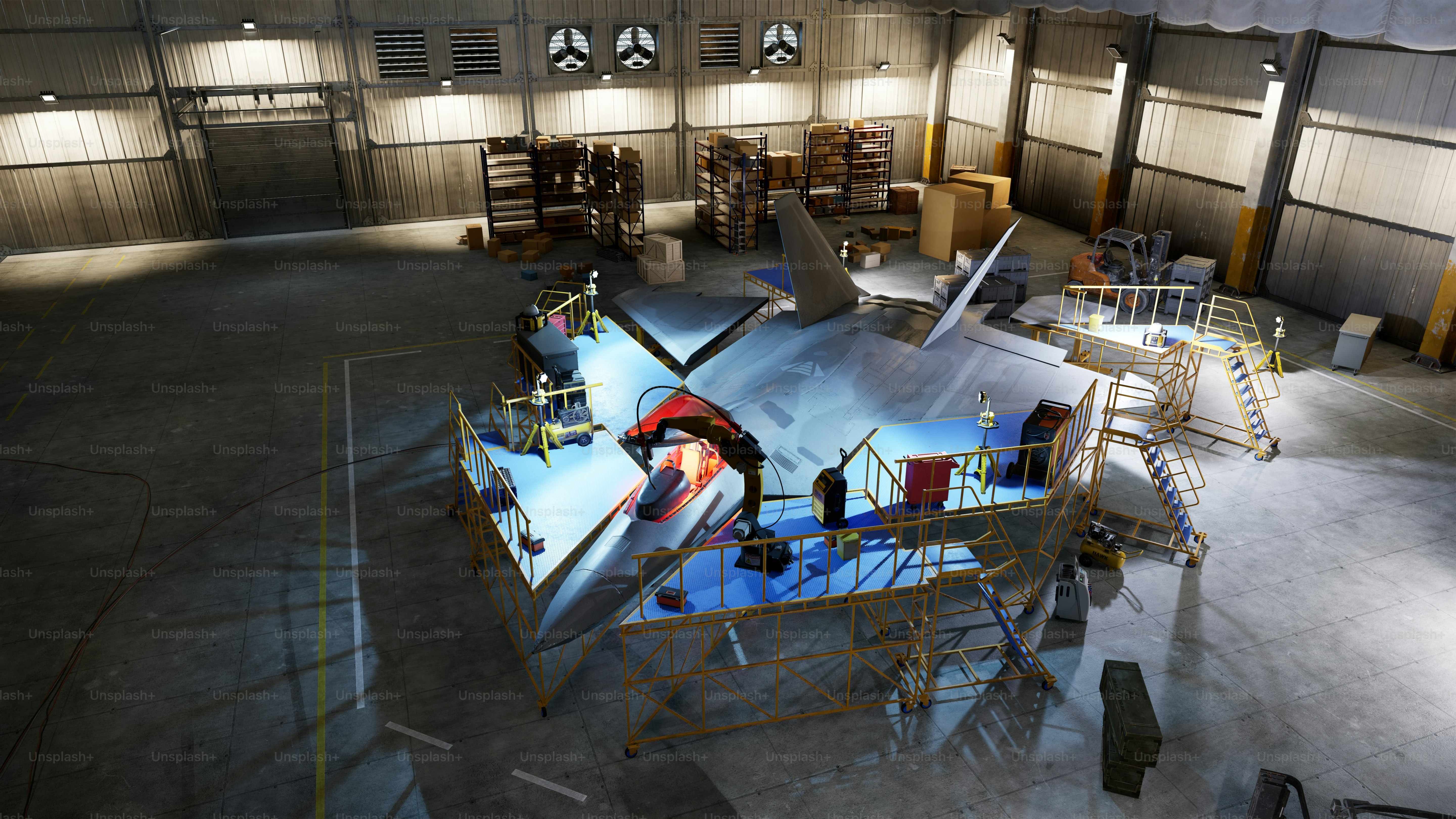An airplane being worked on inside a hangar.