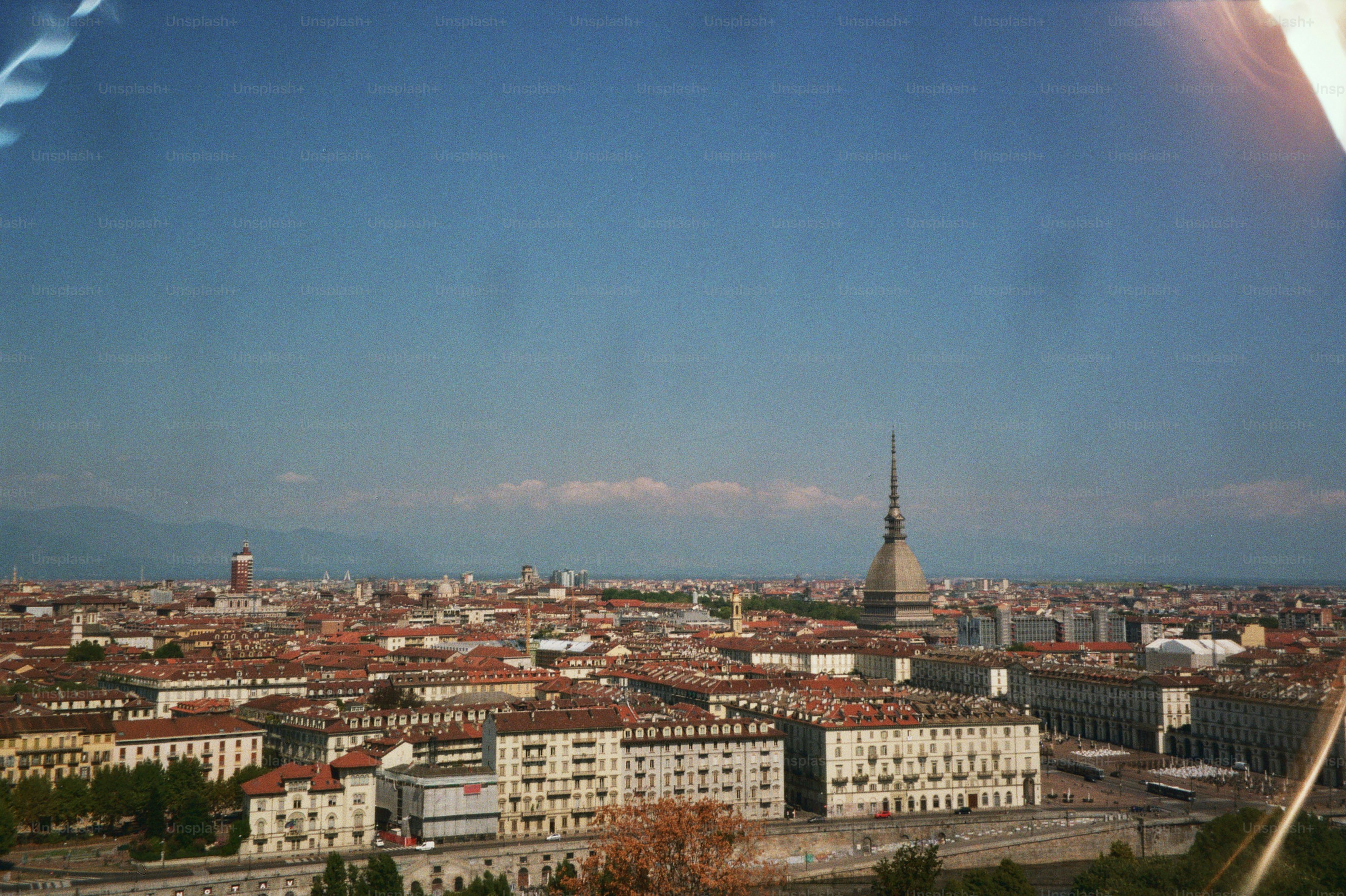 A panoramic view of an italian city under a blue sky.