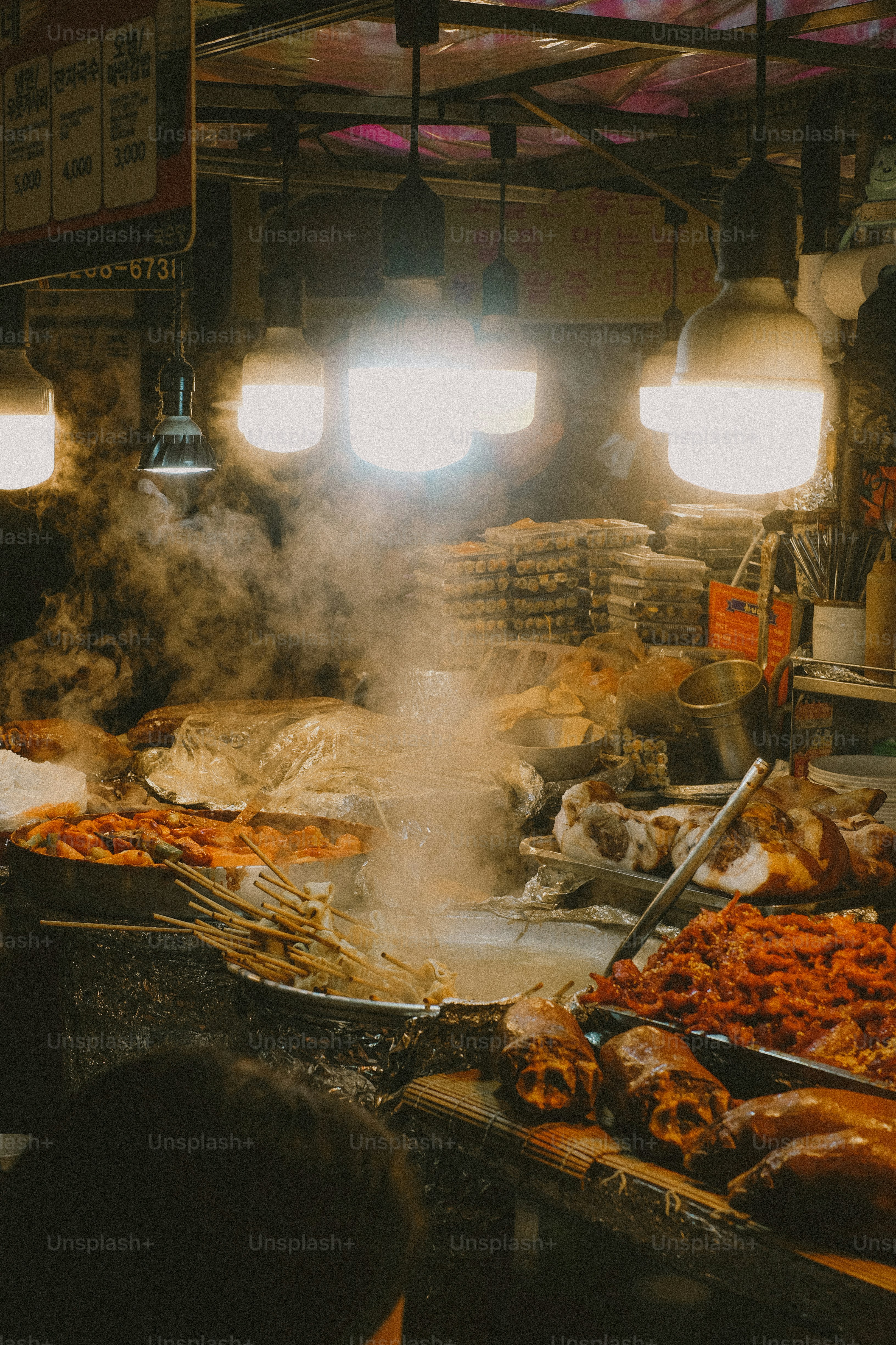 Street food stall is lit and steaming.
