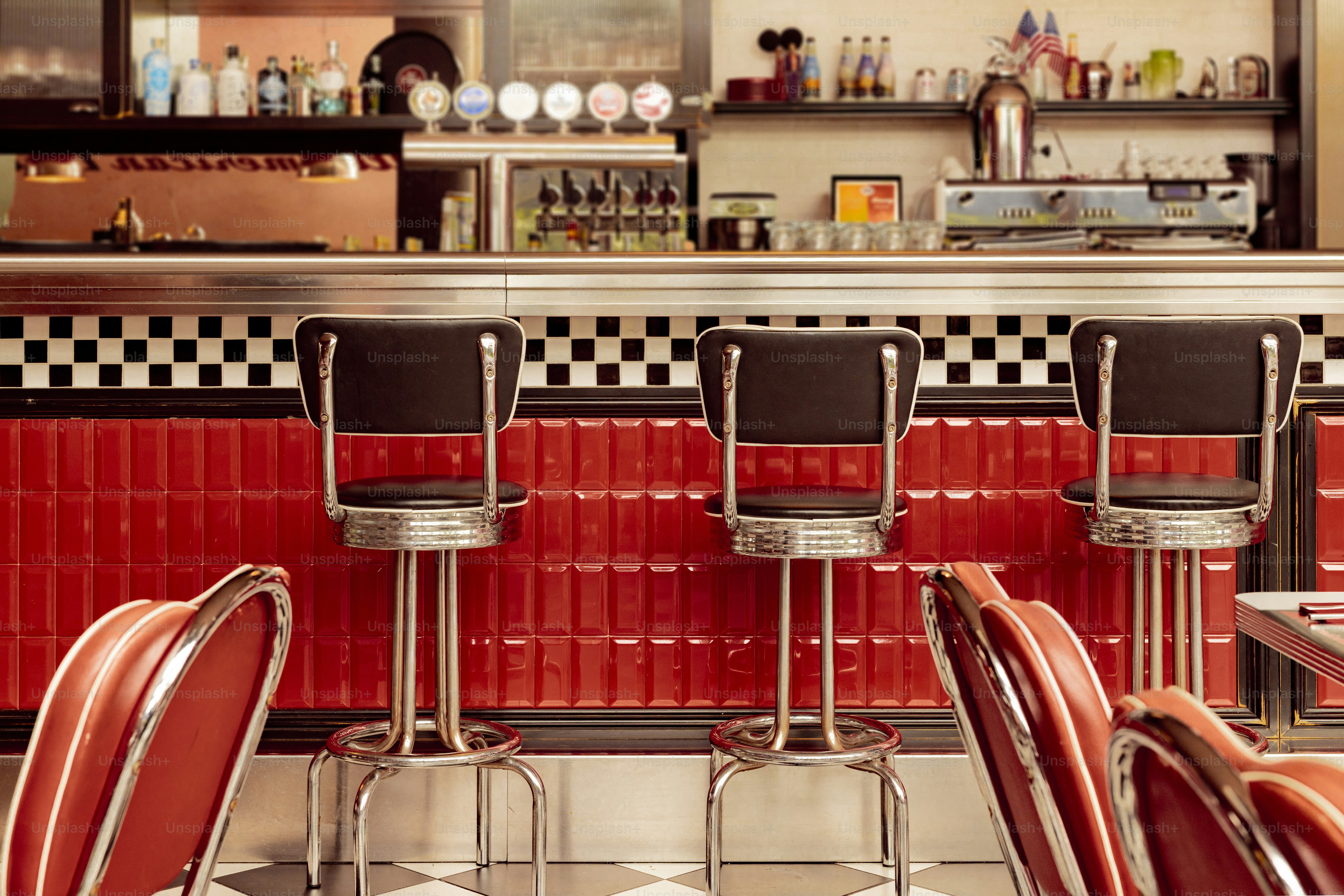 A retro diner bar with stools and seating.