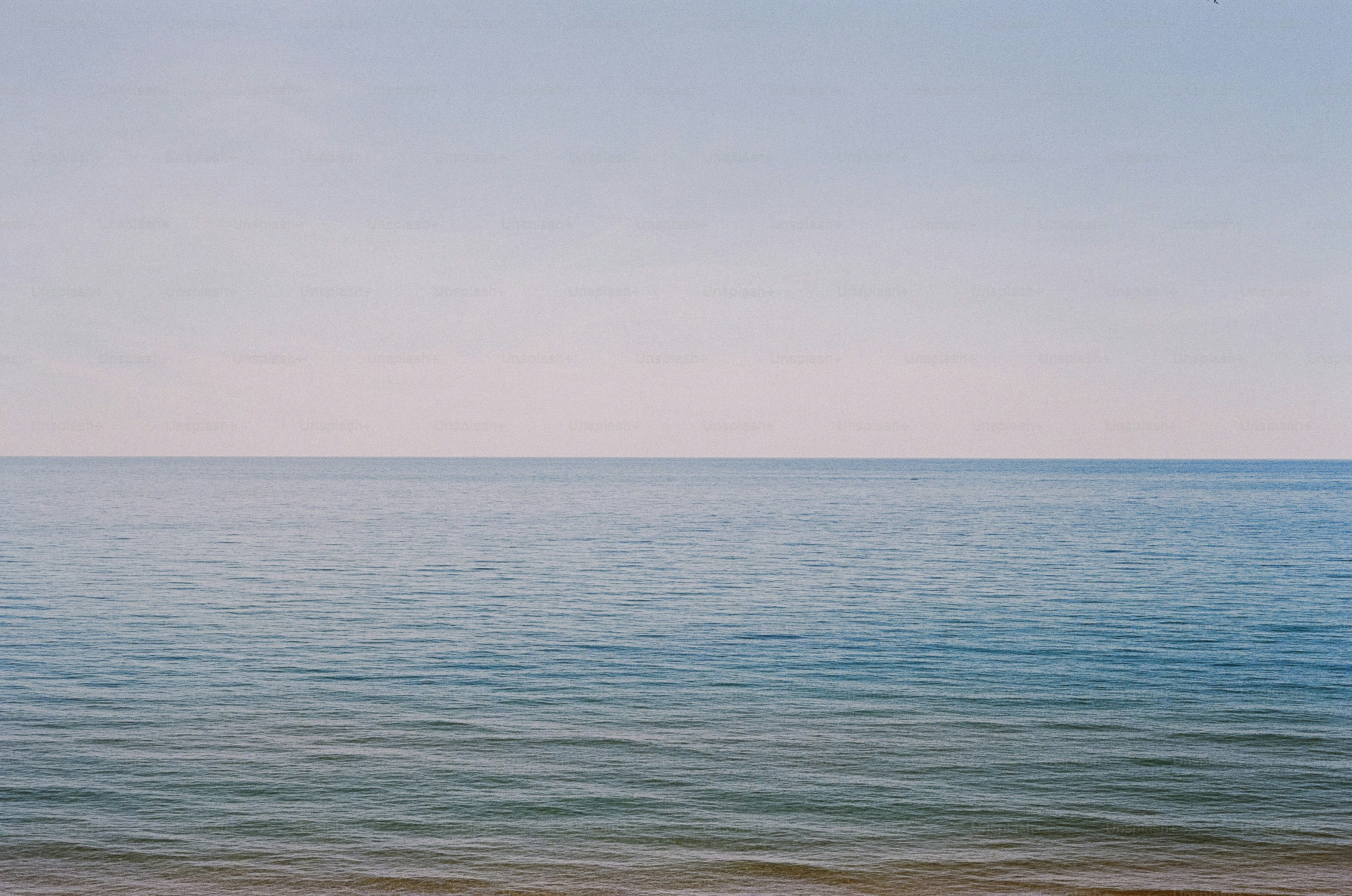 Blue ocean meets a pastel sky.