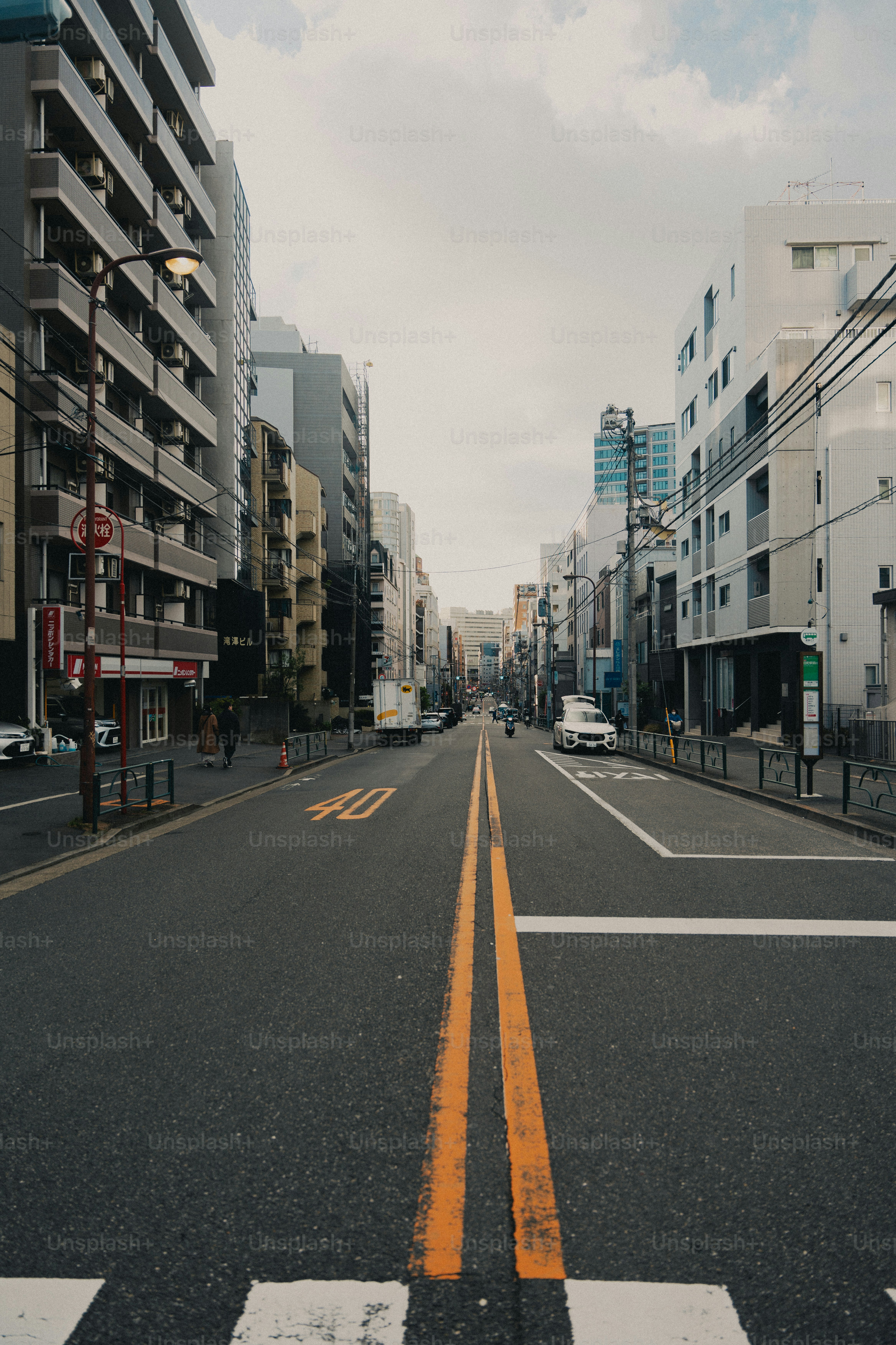 Empty urban street lined with tall buildings.