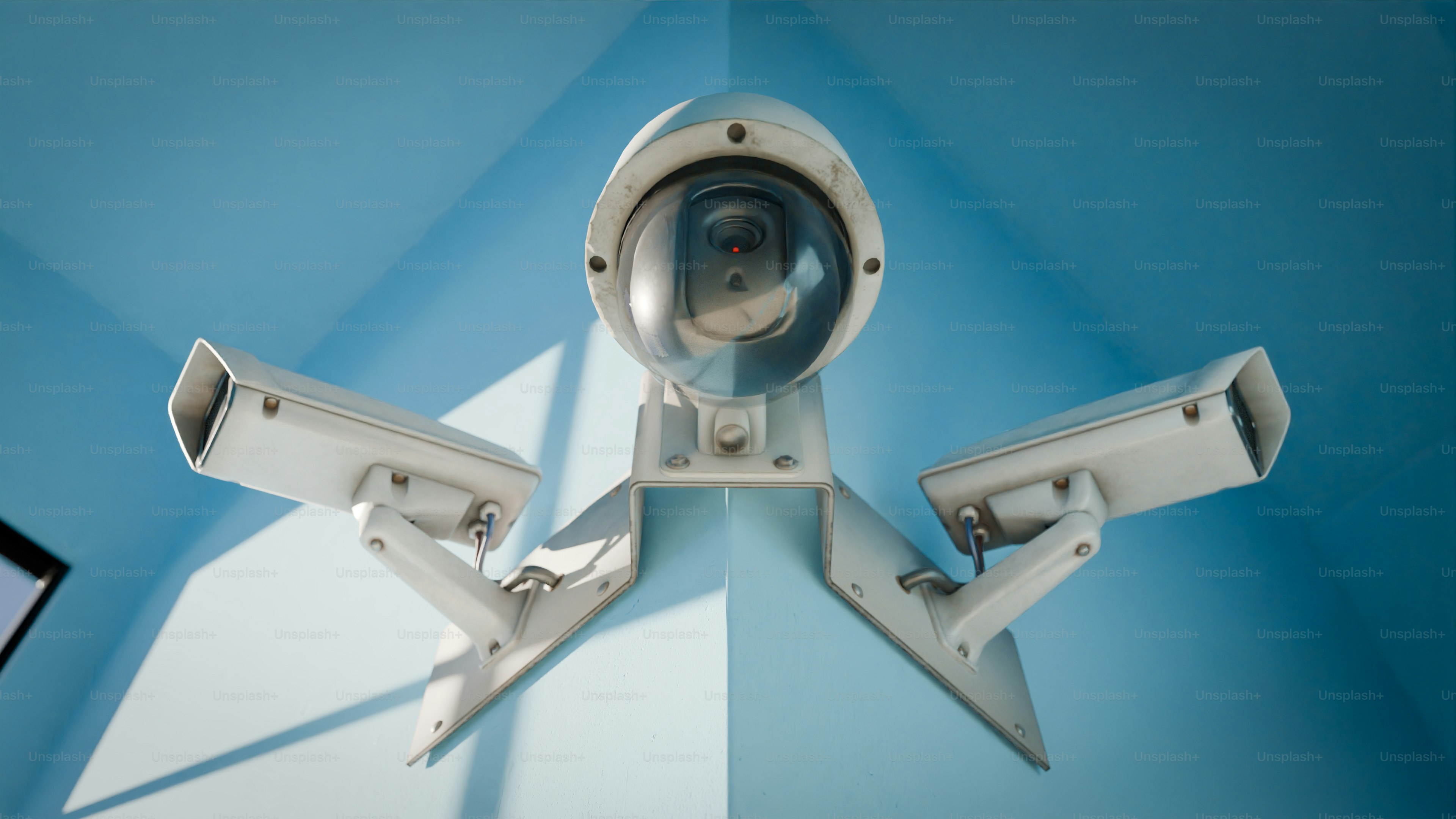 Security cameras are mounted on a corner wall.