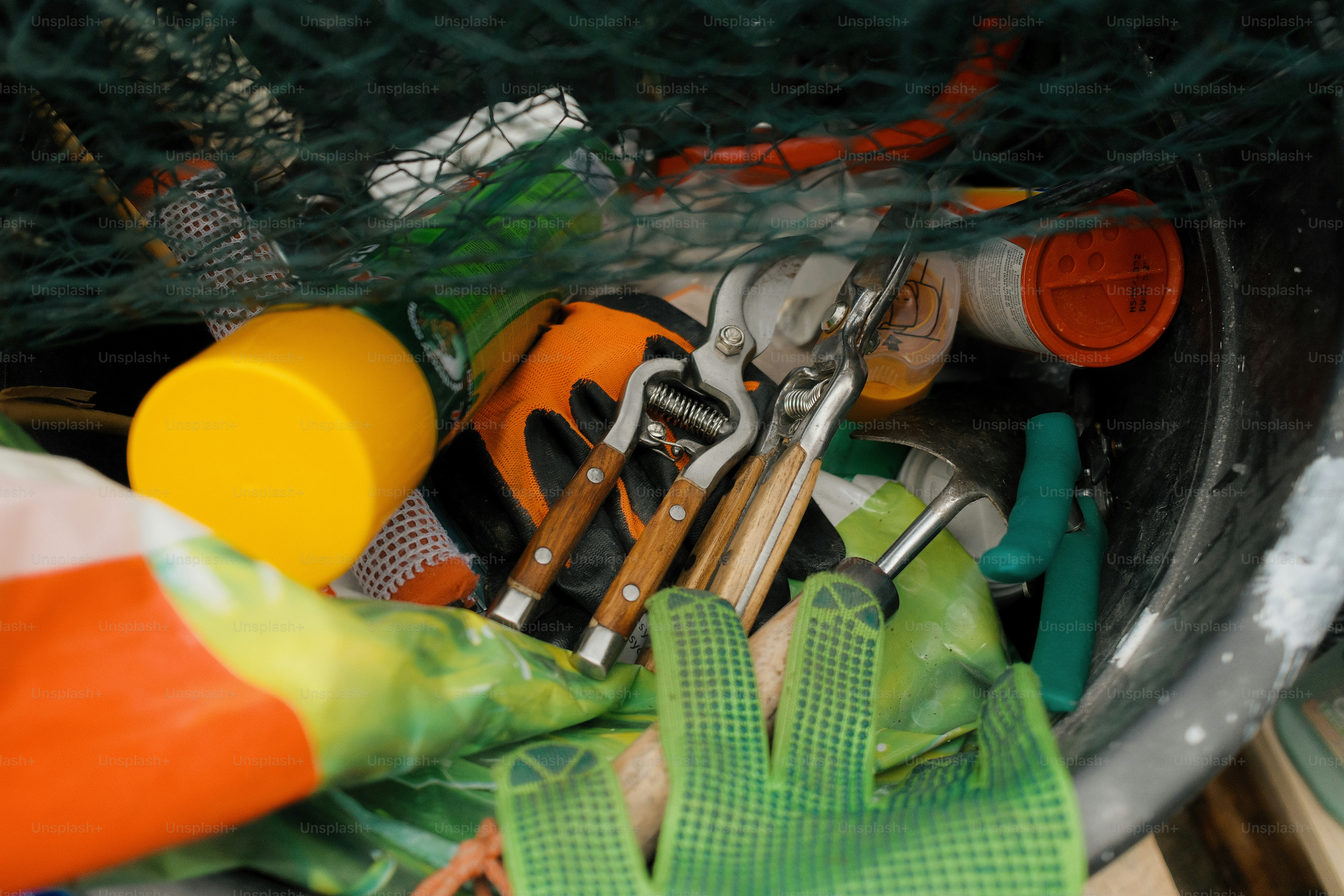 Objects of various shapes and colors fill the container.