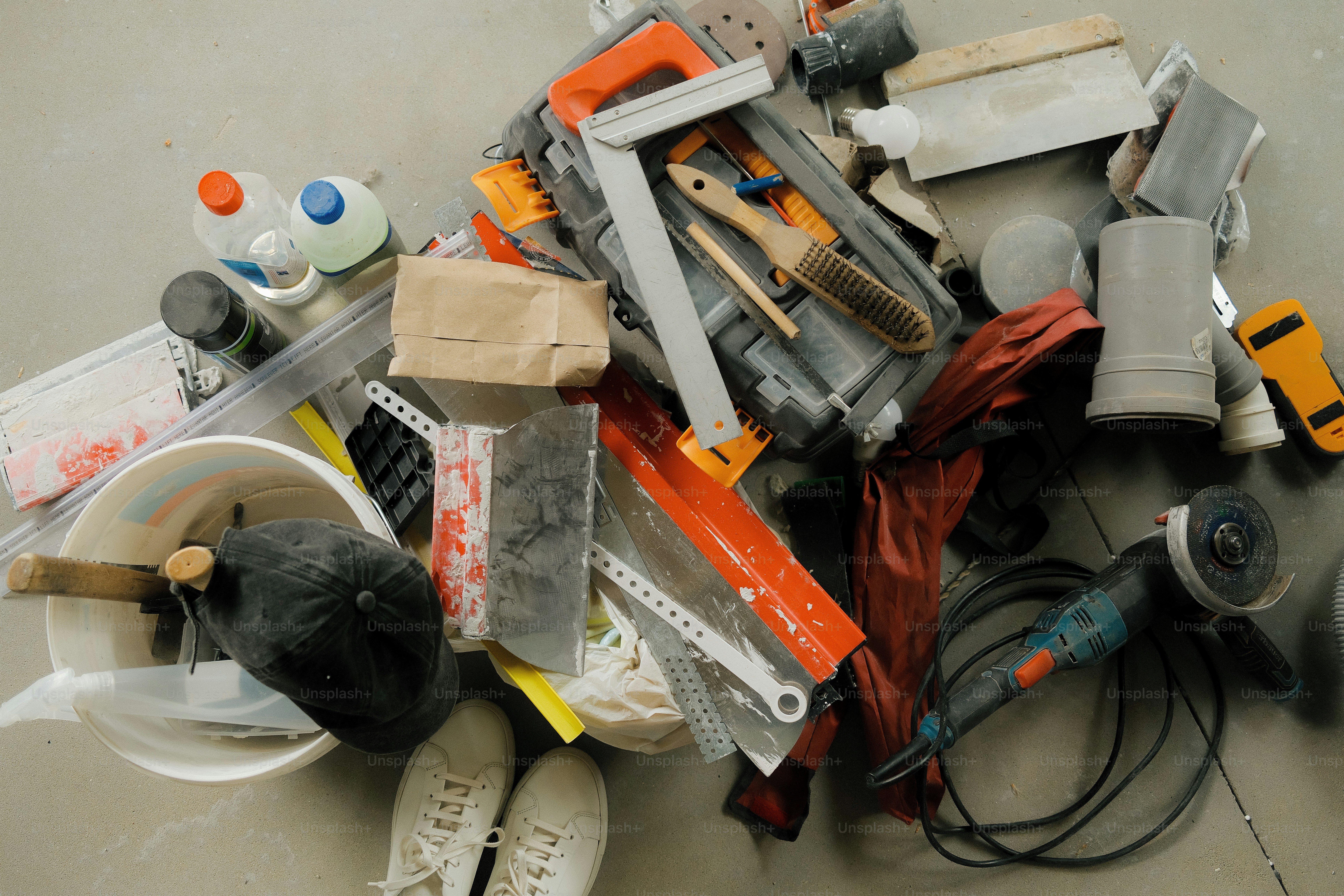 Construction tools and materials are scattered on the ground.